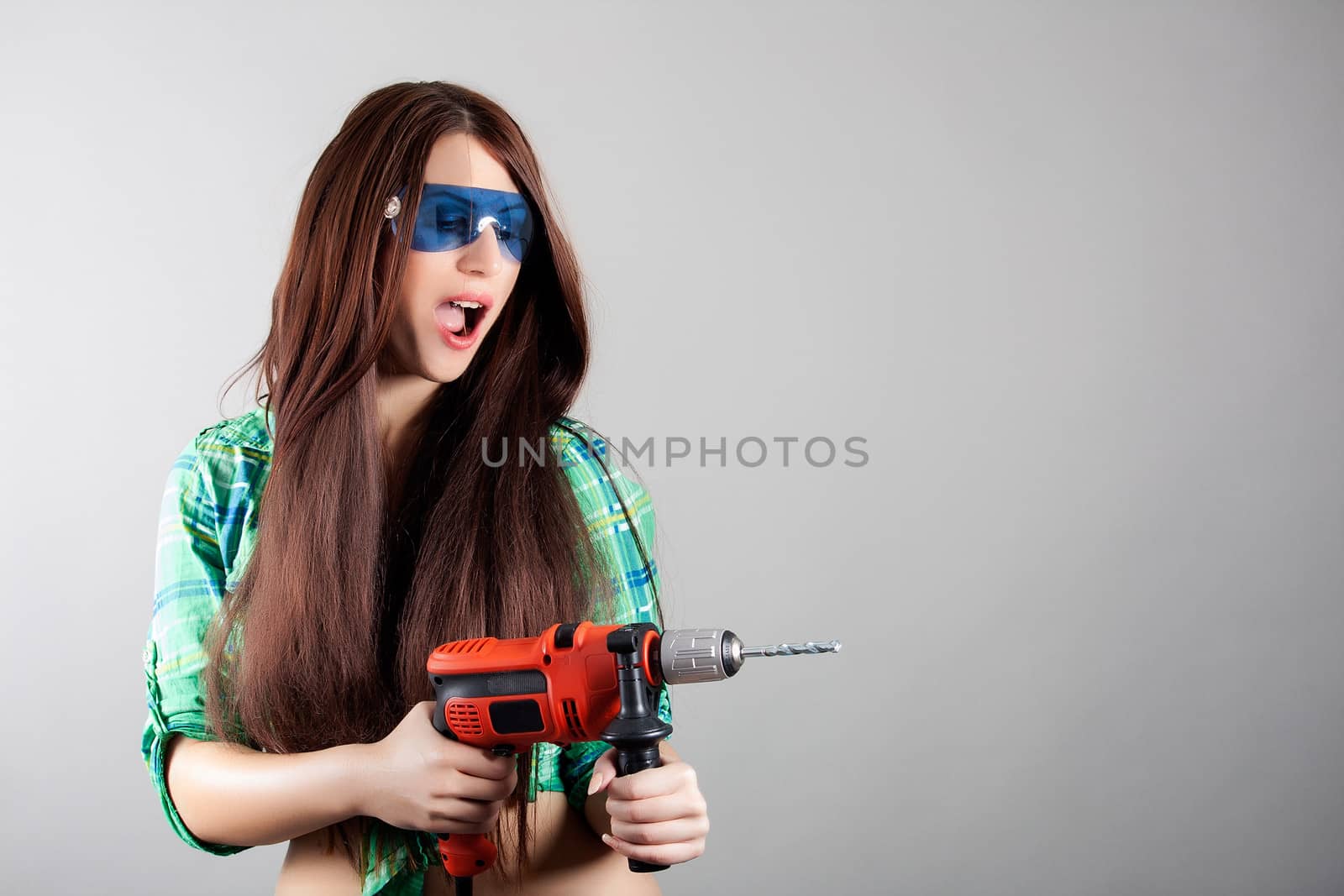 portrait of sexy woman with power drill