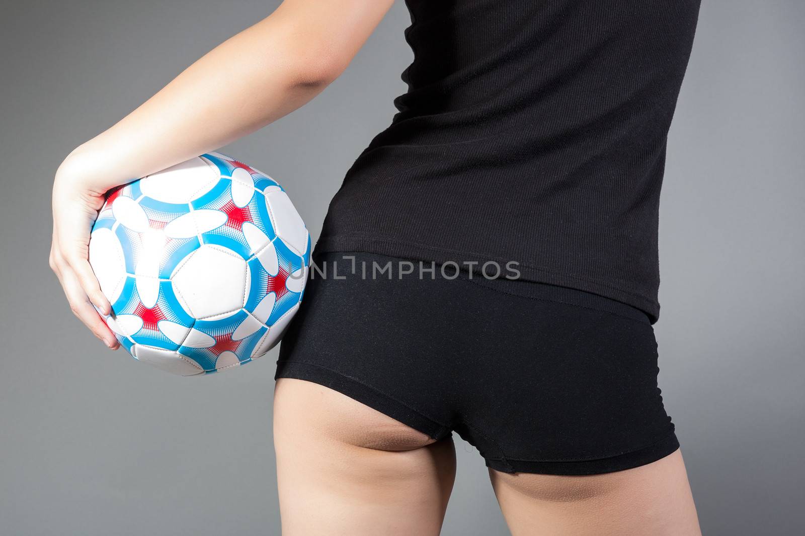 portrait of sexy woman holding a soccer ball