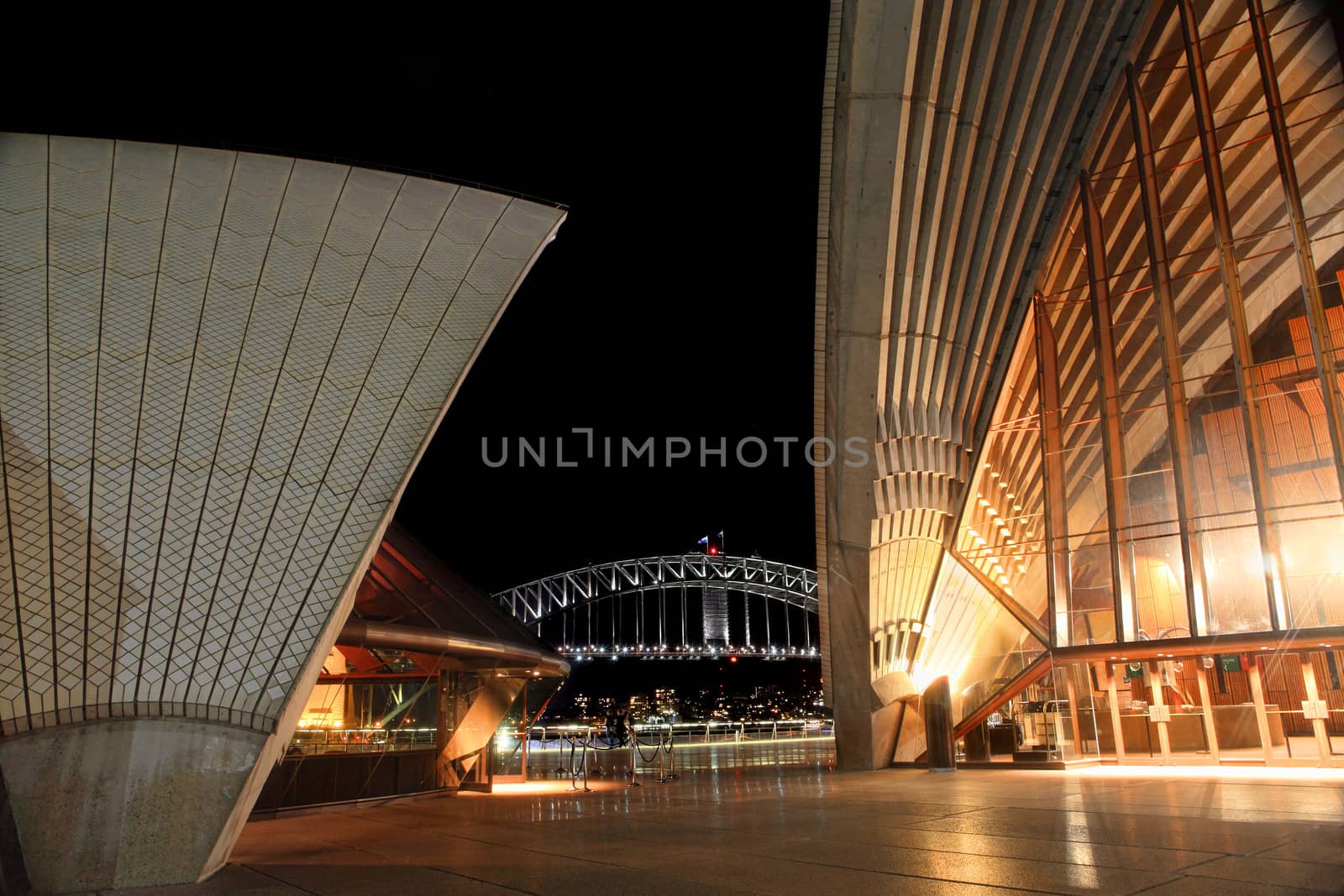 Sydney Opera House and Harbour Bridge lit at night by lovleah