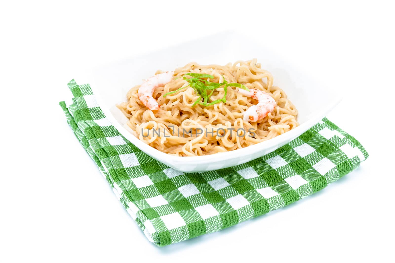 Composition of a bowl of noodles with shrimps on a green cloth