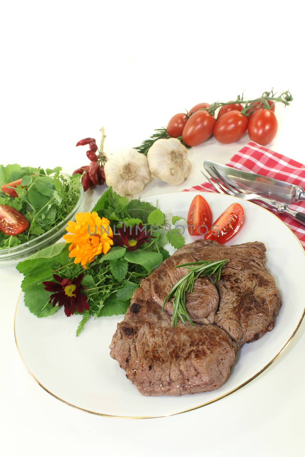 a roasted ribeye steak with wild herb salad