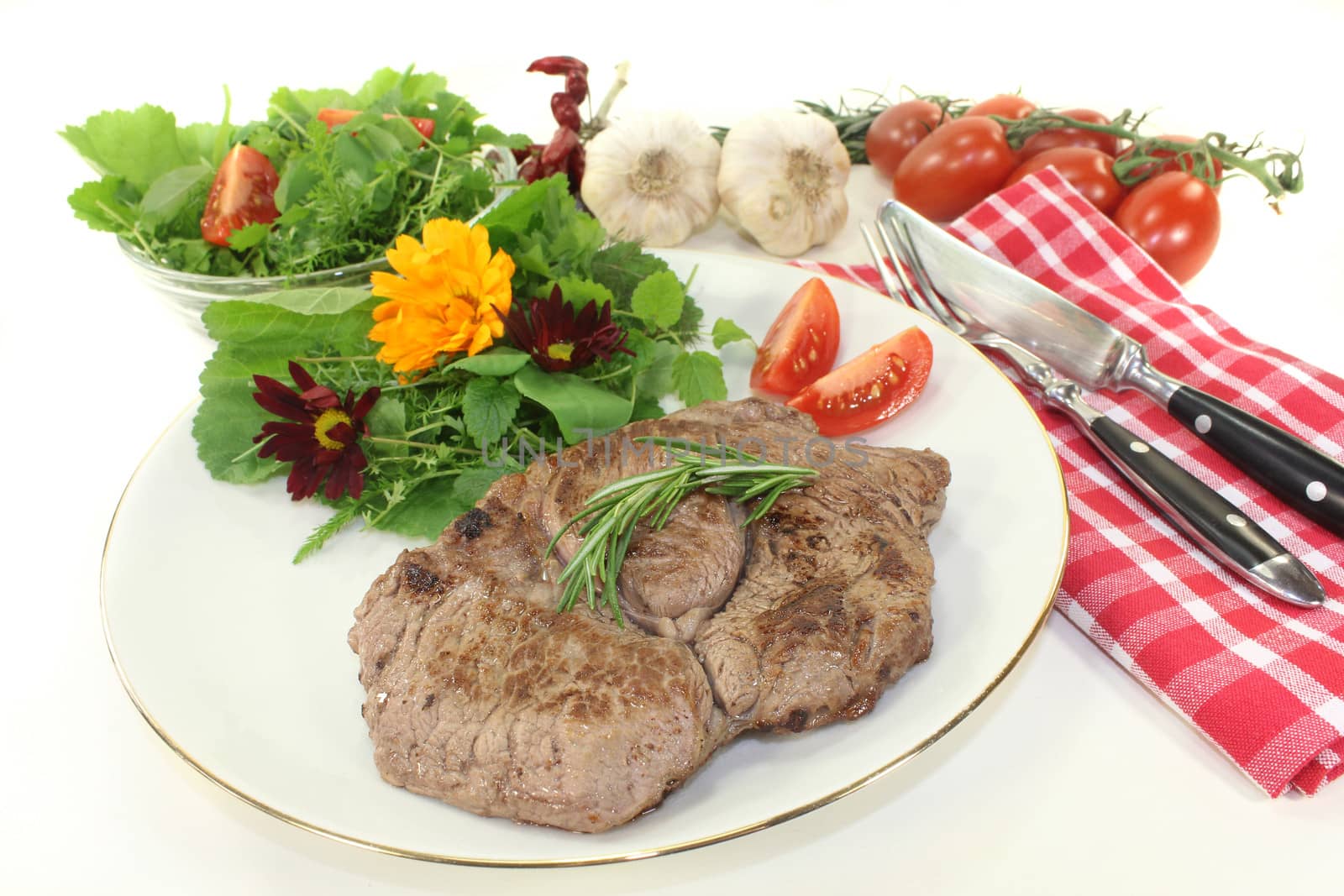 a roasted ribeye steak with wild herb salad