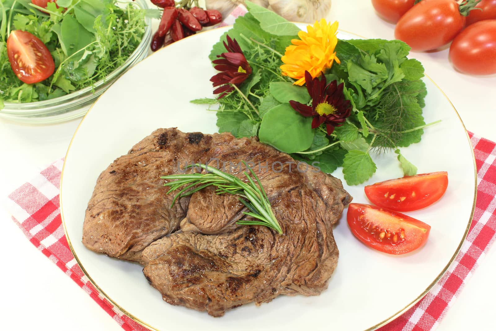 a roasted ribeye steak with wild herb salad