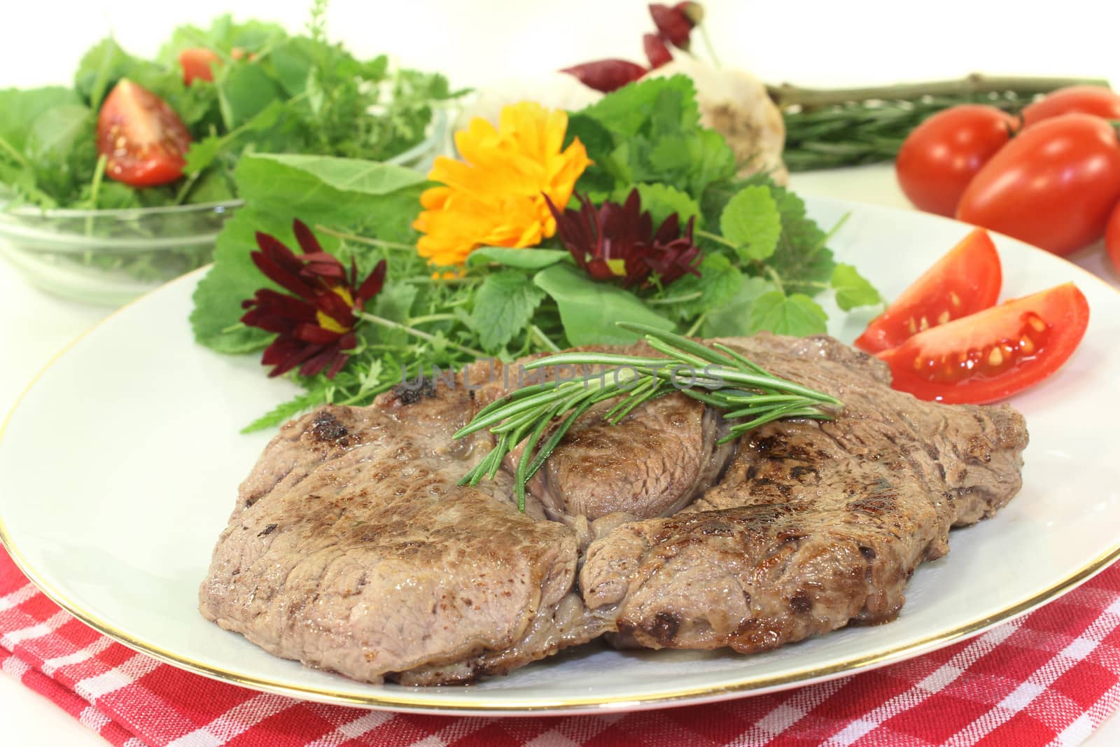 a roasted ribeye steak with wild herb salad