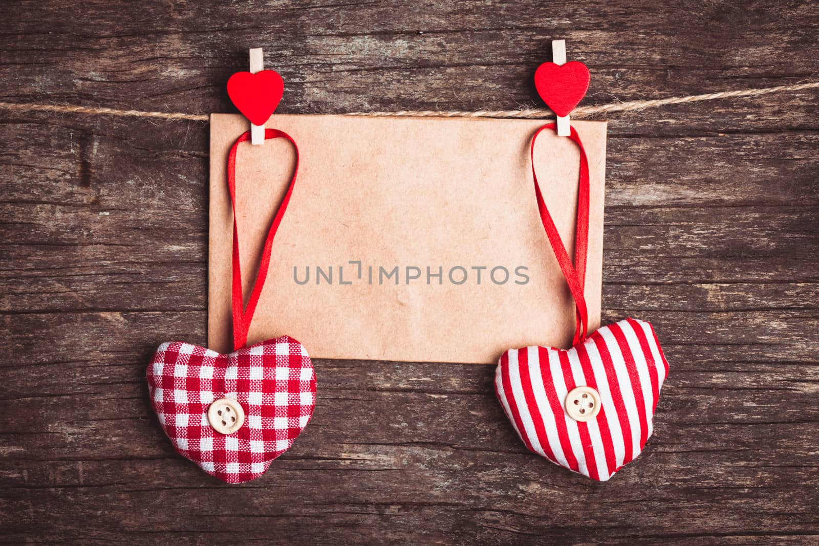 Two hearts and craft envelope .attached to the rope. Valentine greetings