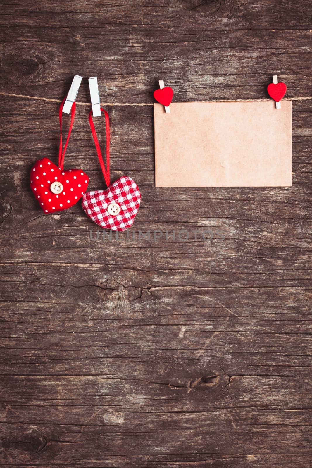 Two hearts and craft envelope .attached to the rope. Valentine greetings