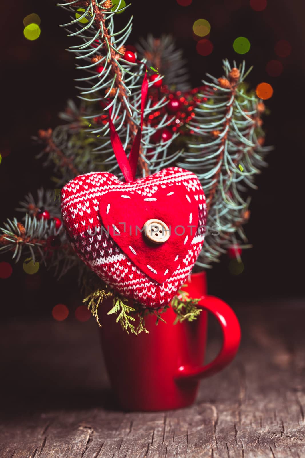 Handmade knitted heart - christmas decoration on the fir branch