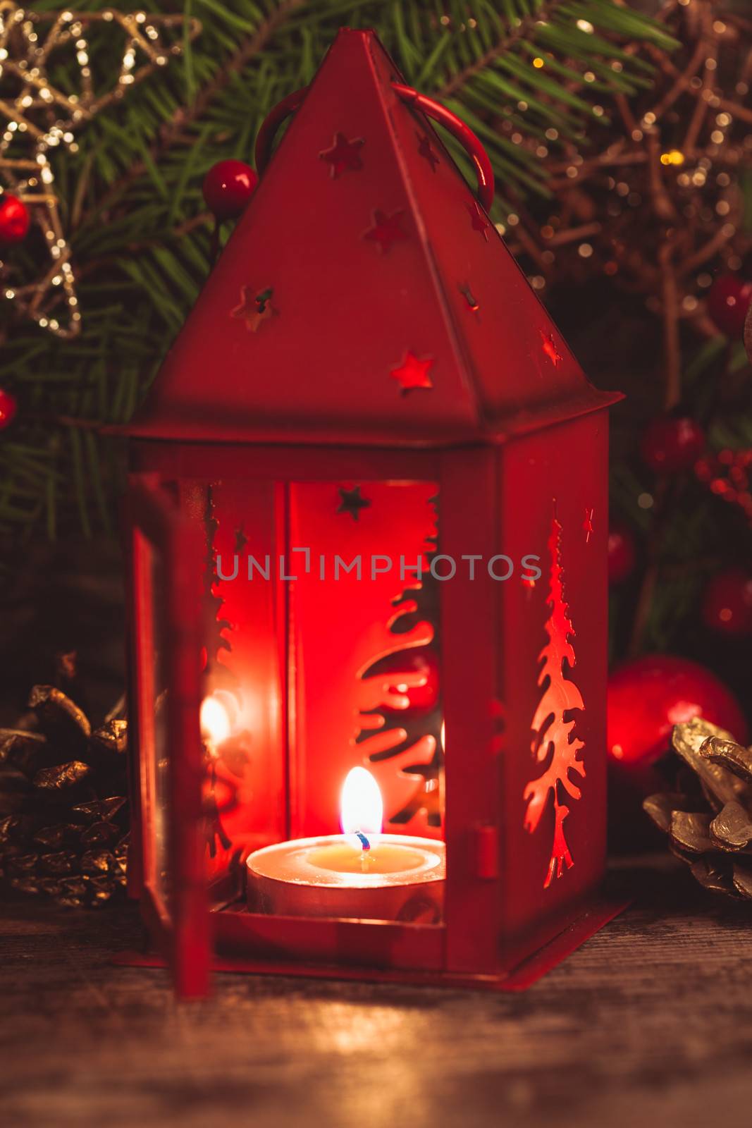 Red christmas candlestick over holiday decorations on the table