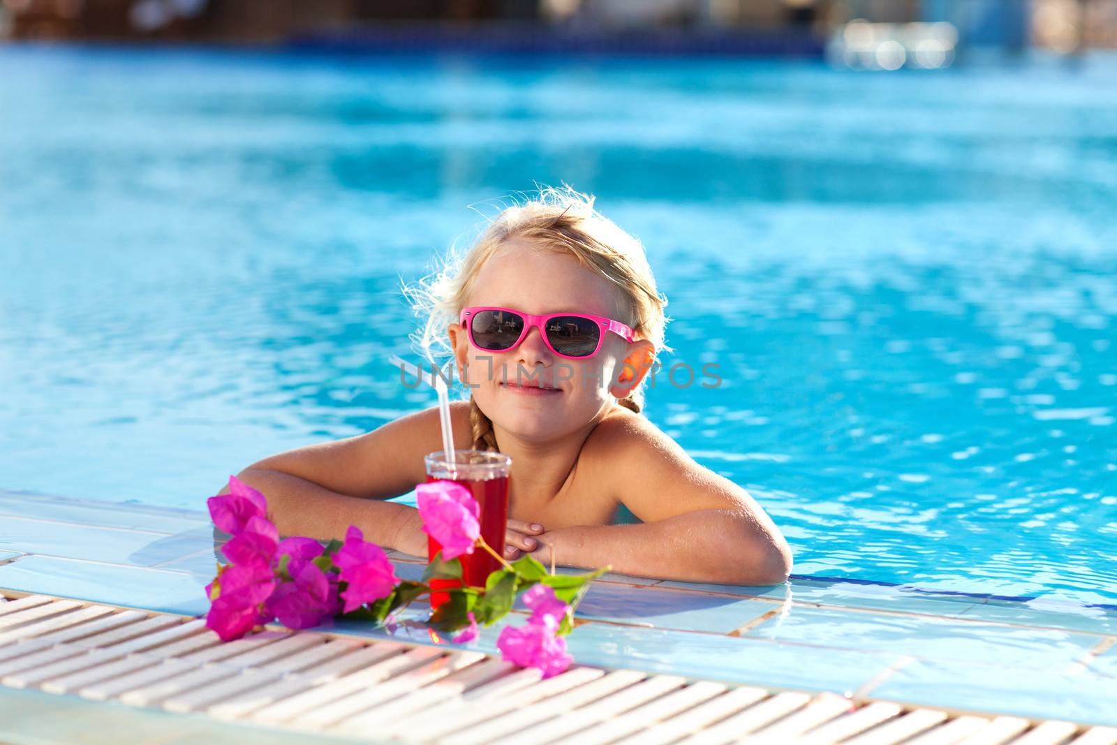 girl drinking coctail in the pool by vsurkov
