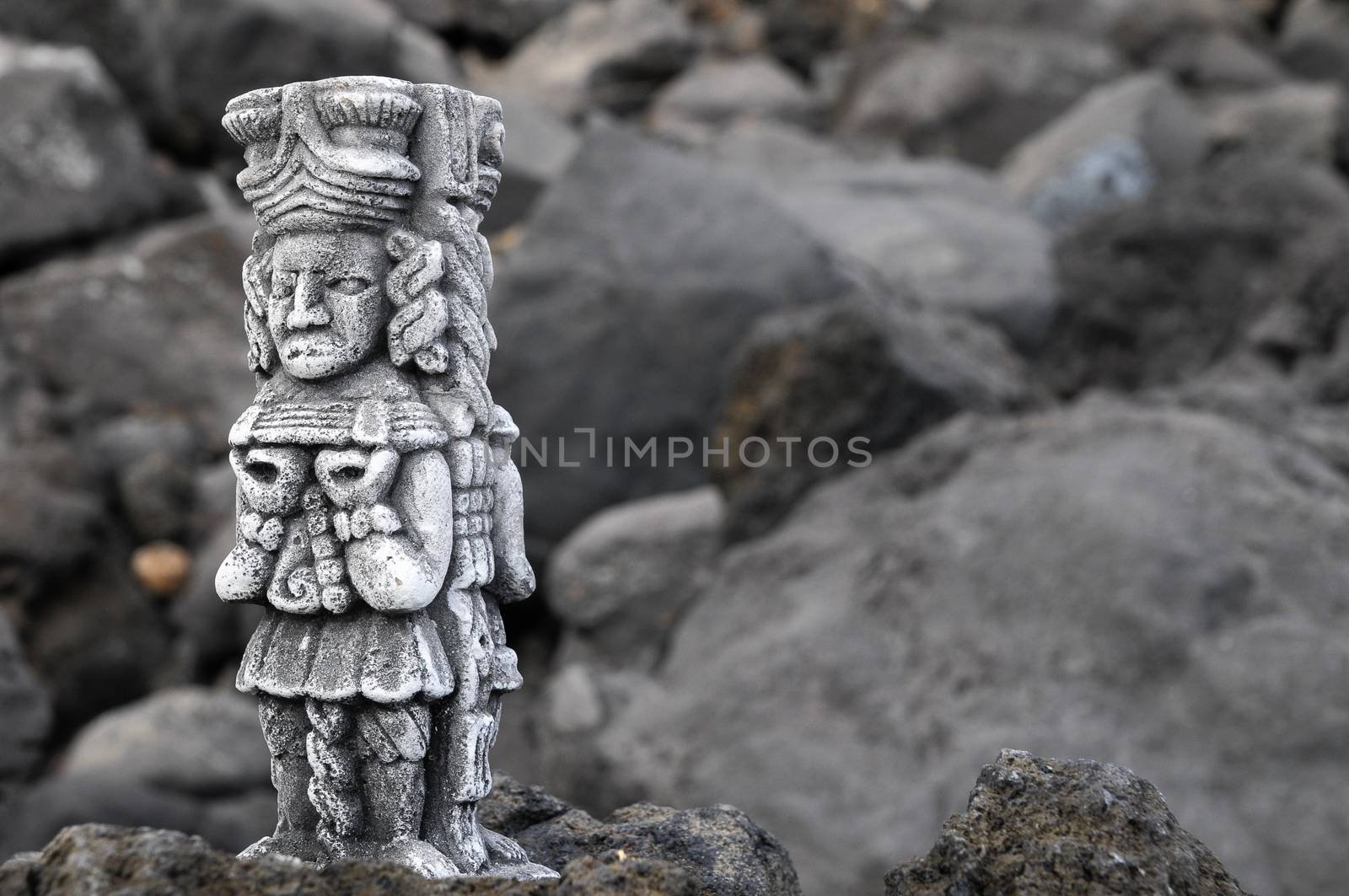 Ancient Maya Statue on the Rocks near Ocean