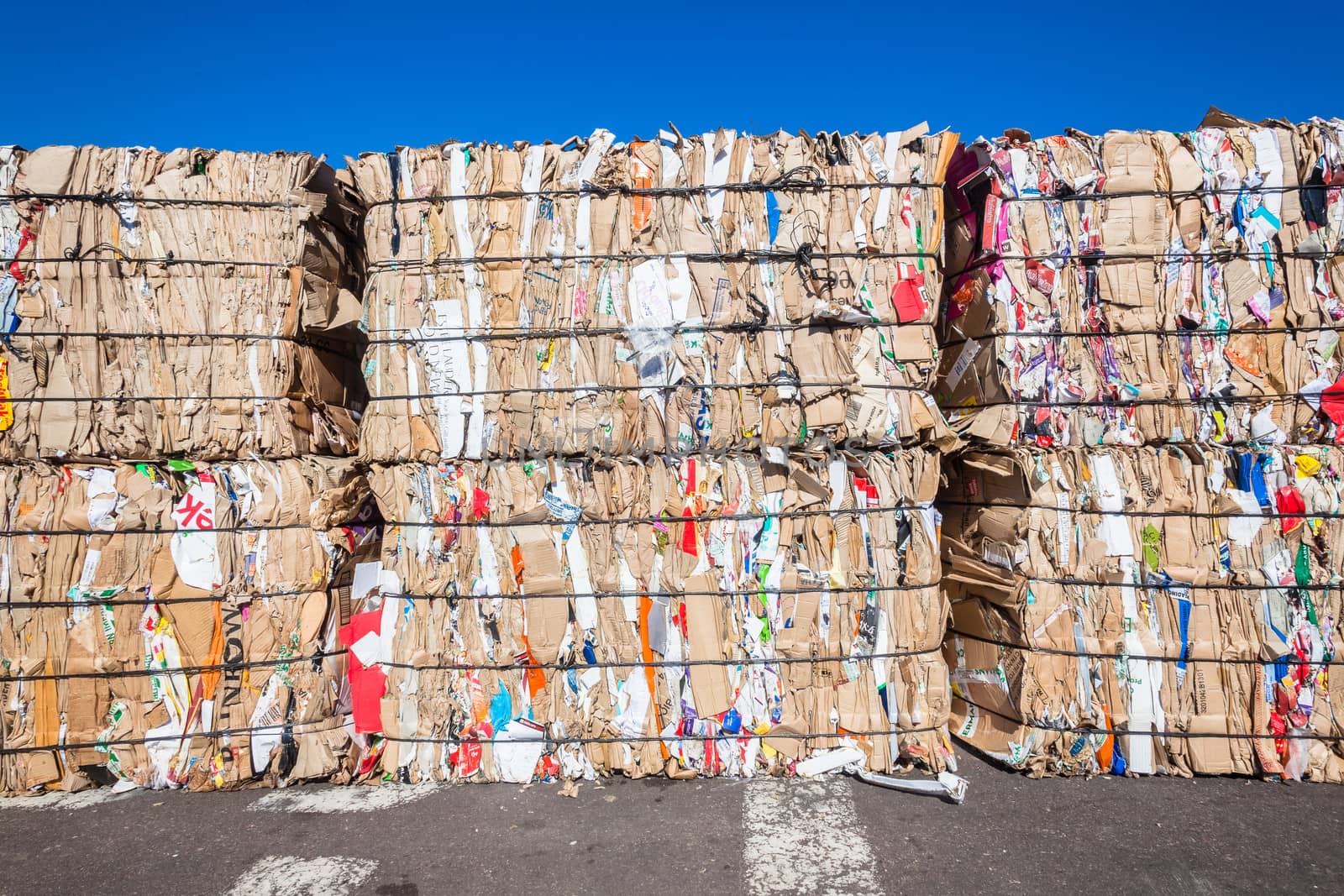 Cardboard paper packed strapped and packed in stacks for recycling pulp.