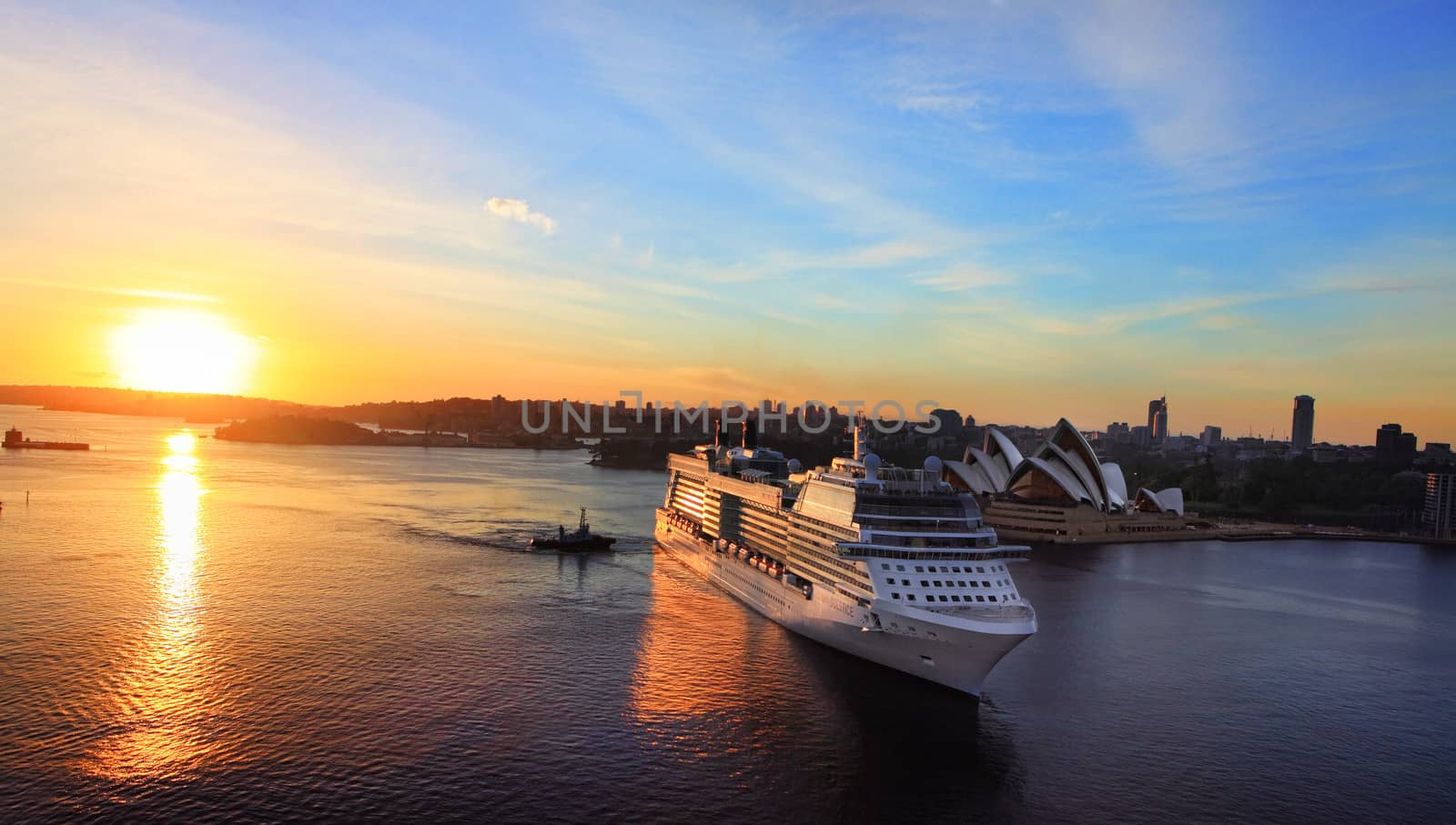 Sydney, Australia - November 28, 2013:  Celebrity Solstice, one of Australia's highest rated superliners sails into Sydney Harbour Circular Quay at sunrise. Focus to ship