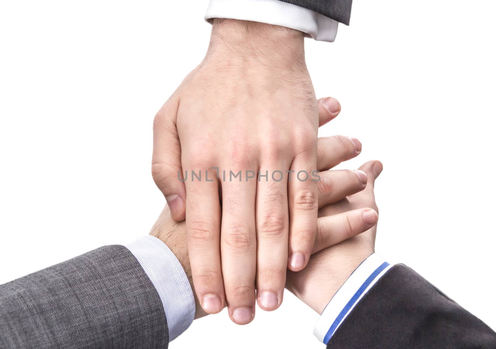 Closeup of business team showing unity with hands together isolated on white background