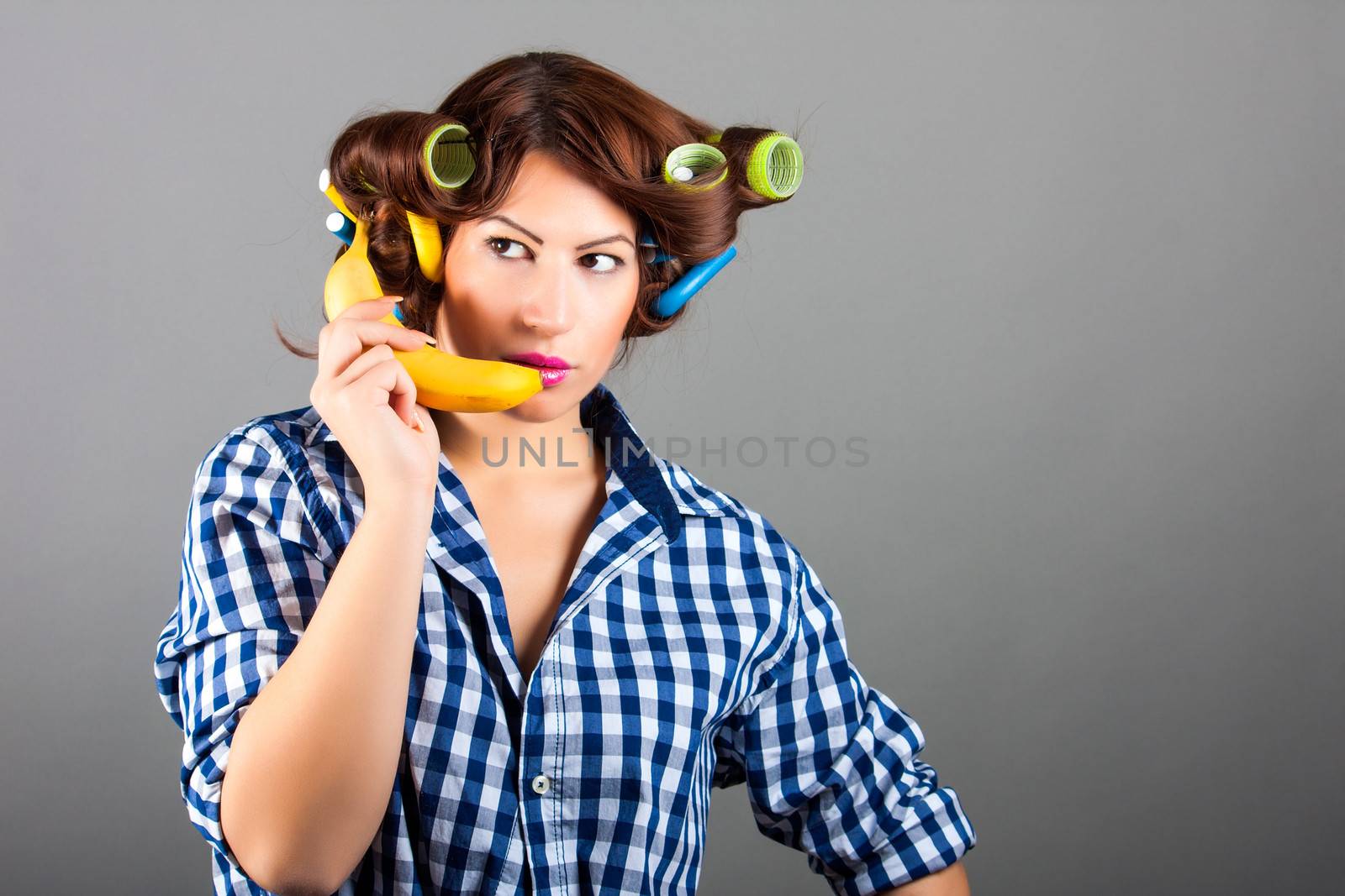 portrait of girl holding banana like cell phone