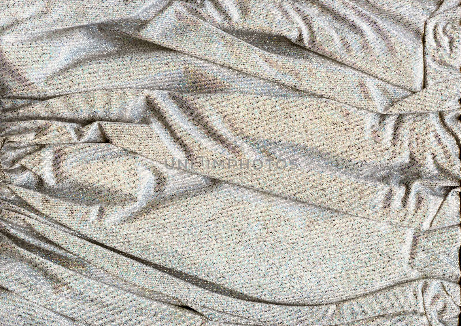 Texture of shiny silver fabric with folds