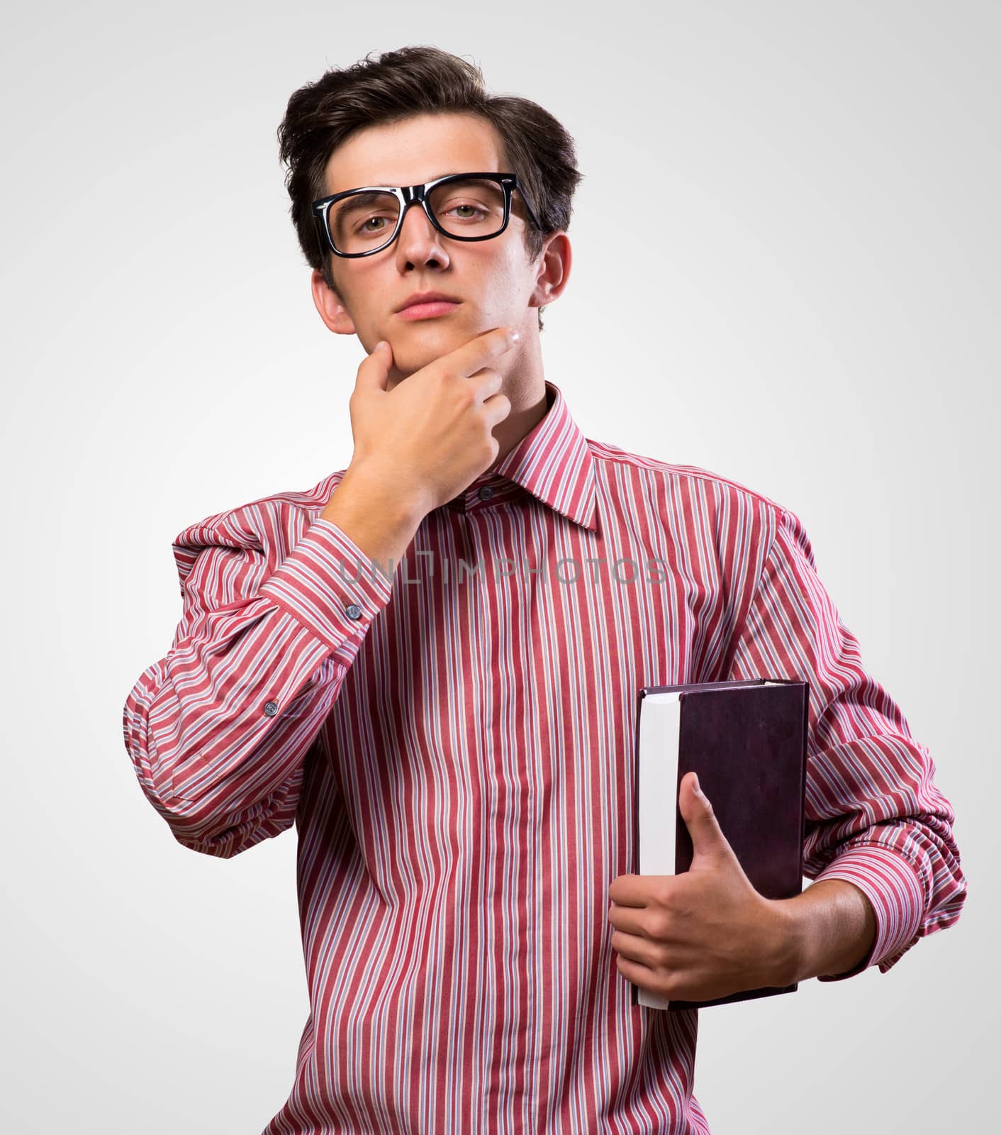 thoughtful man with a book, looking at camera