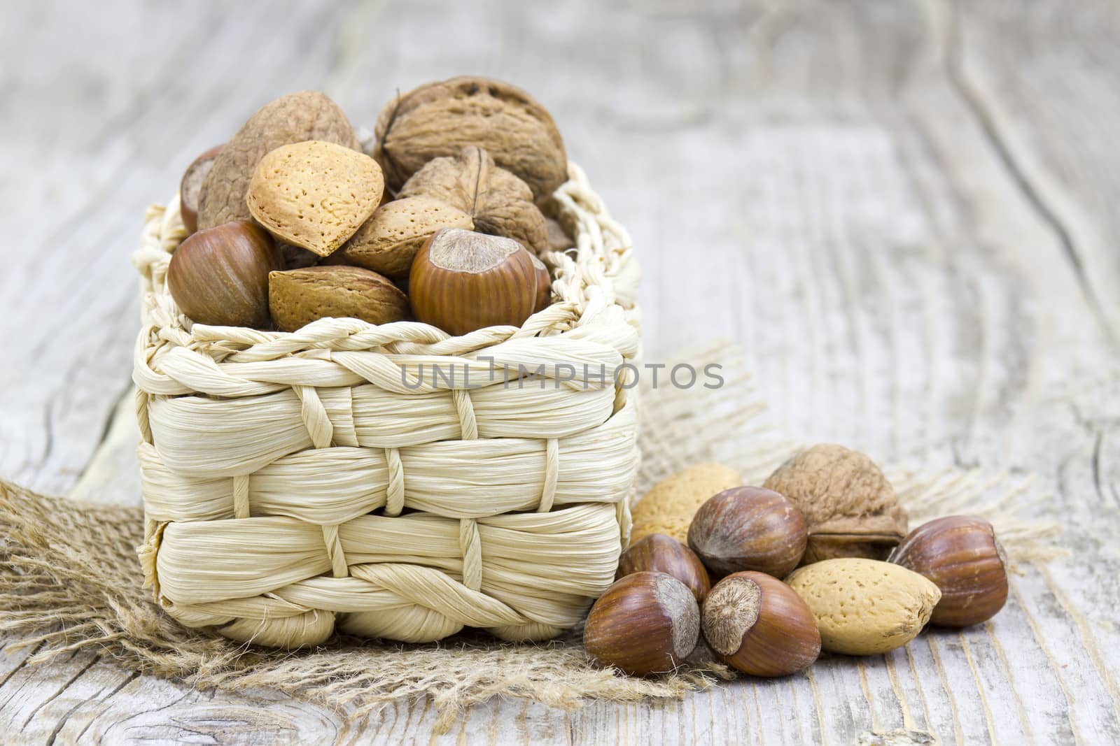 nuts in a basket on old wooden background