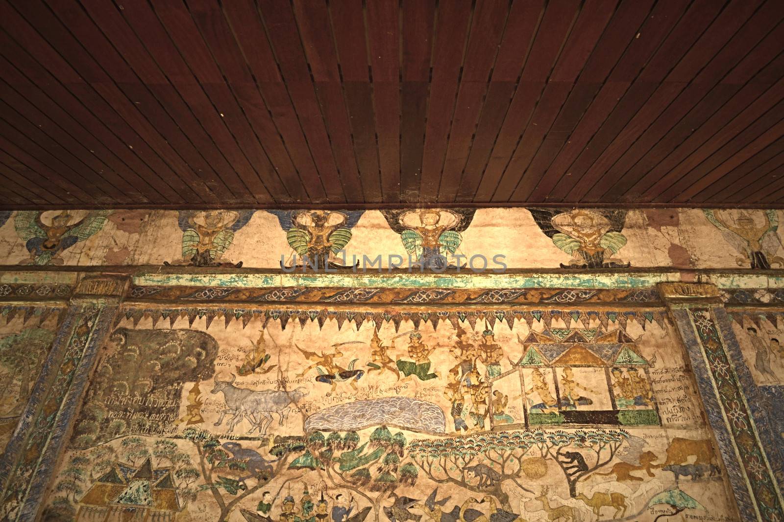 Public mural painting at old temple in Thailand