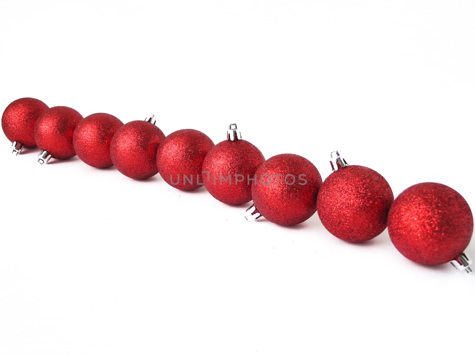 Christmas balls on white background located in one row