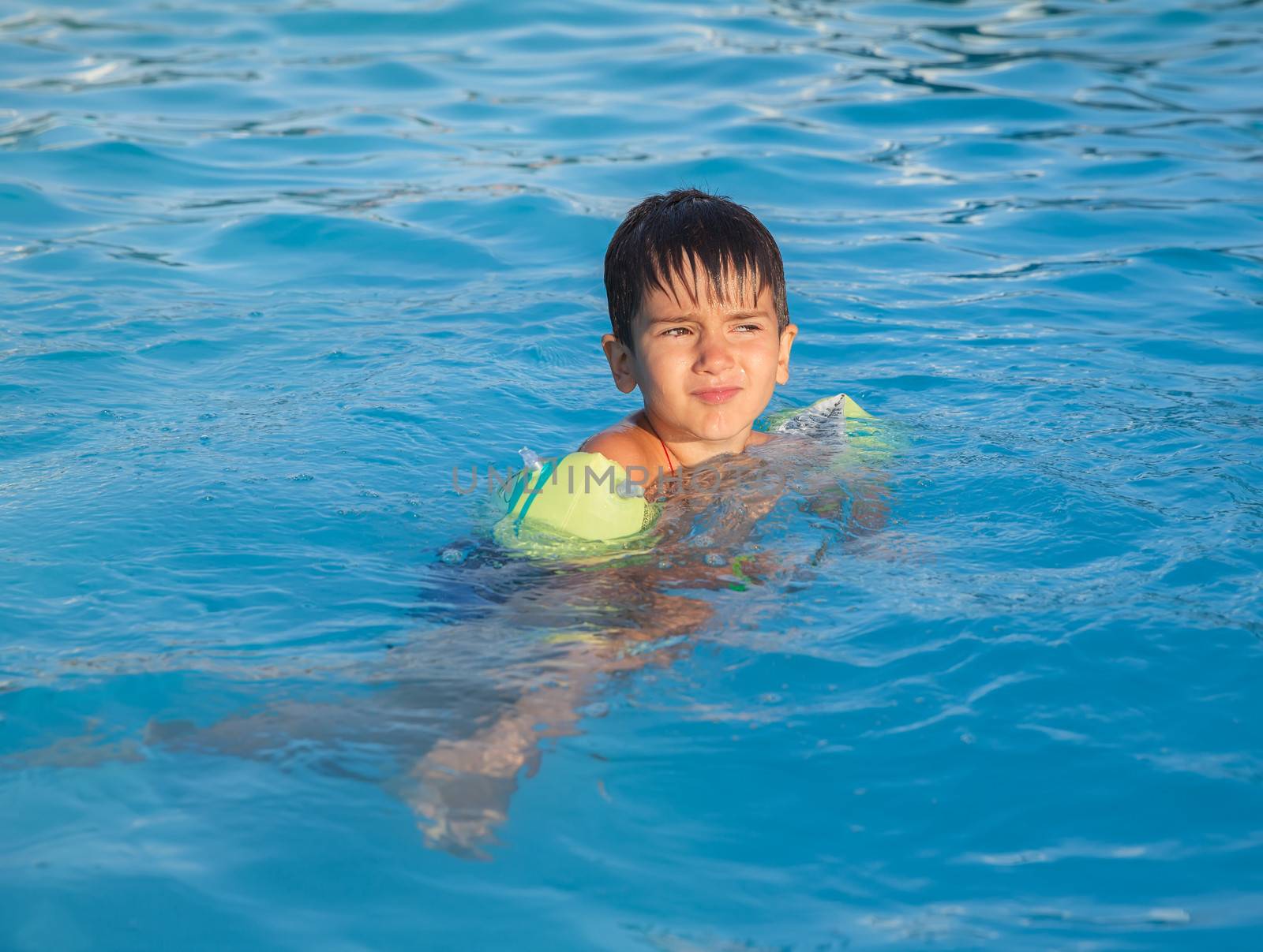 Little boy learning to swim in the pool  by palinchak