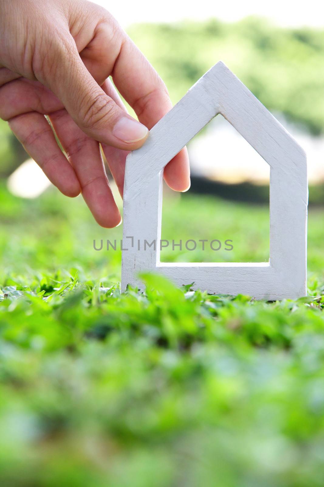 Hands holding icon house by ponsulak