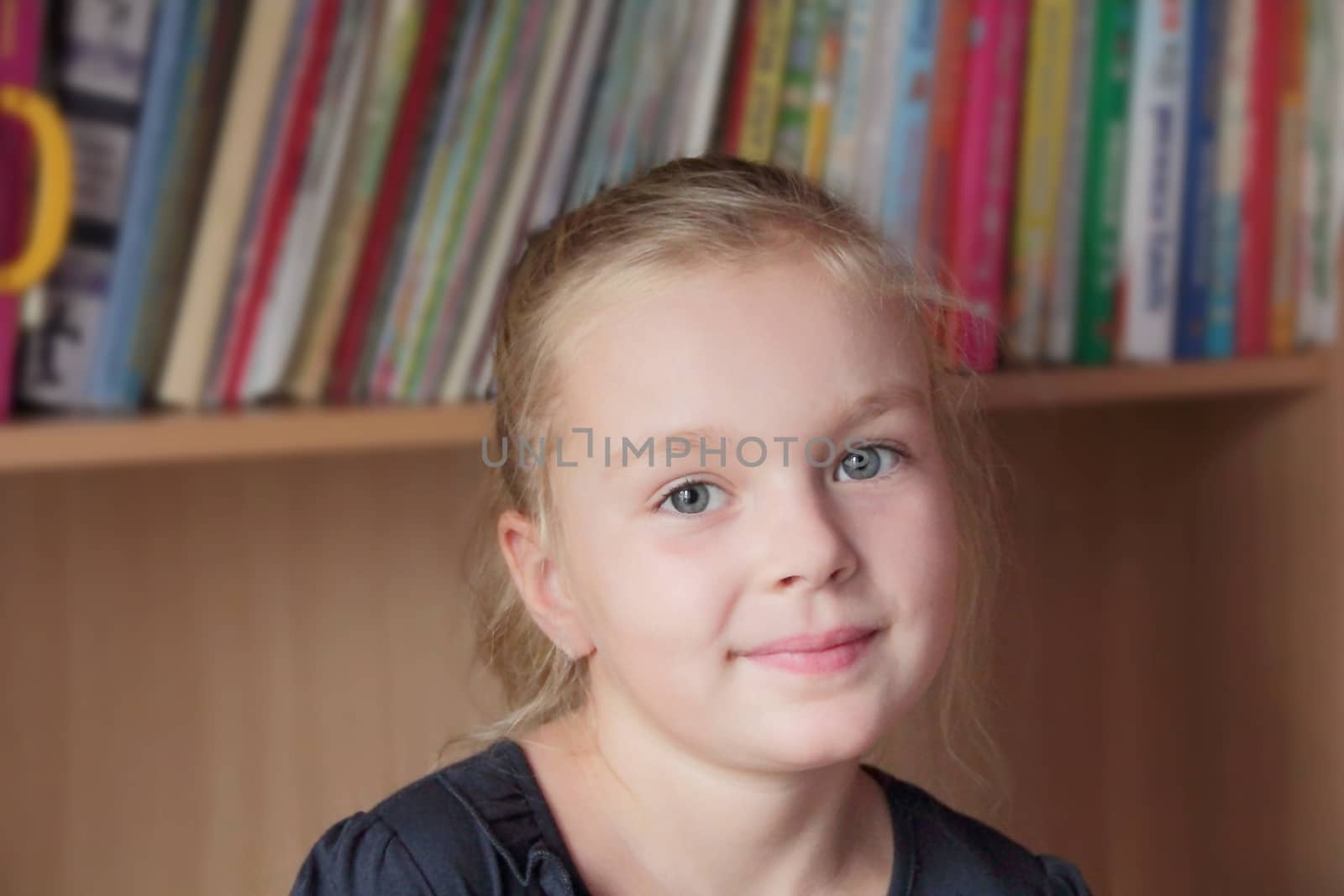 Portrait of beautiful girl on books background