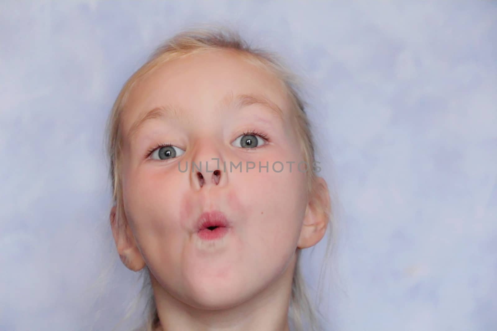 Portrait of beautiful girl with blond hair and blue eyes