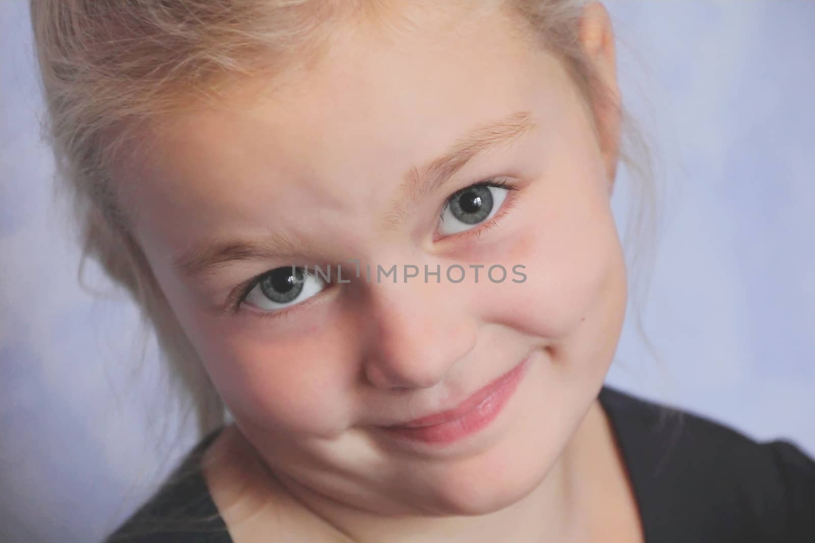 Portrait of beautiful girl with blond hair and blue eyes