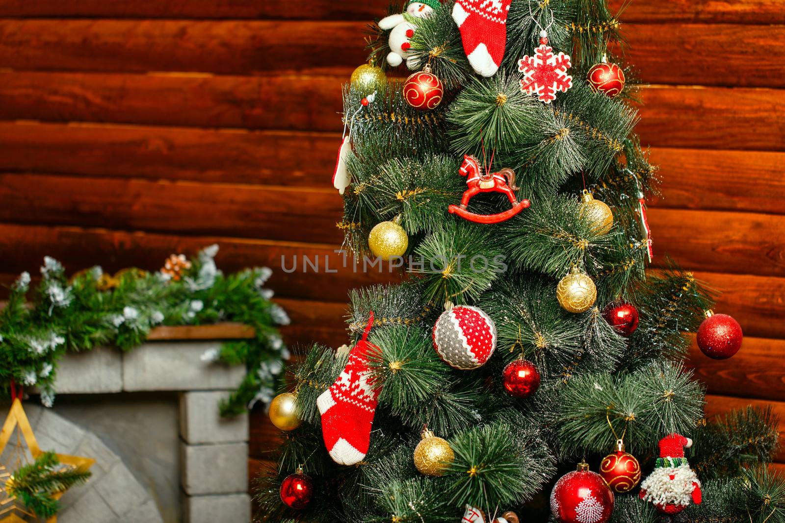 Christmas tree decorated with toys and gifts photographed closeup