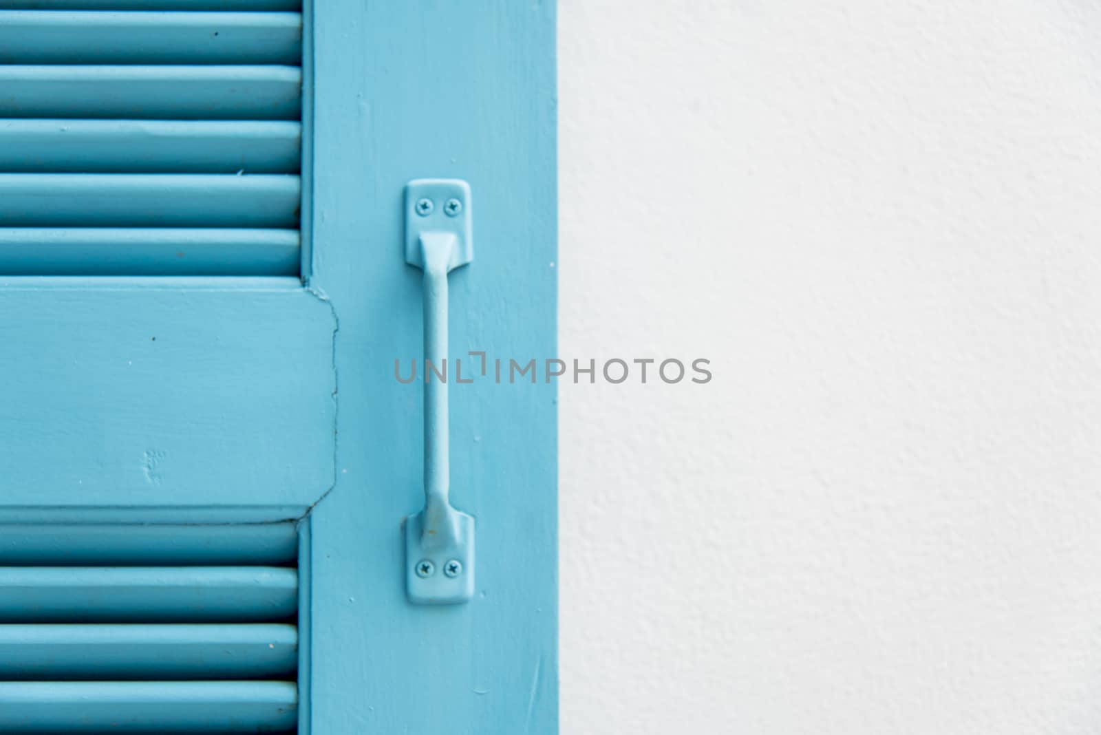 Blue wooden window on white wall4