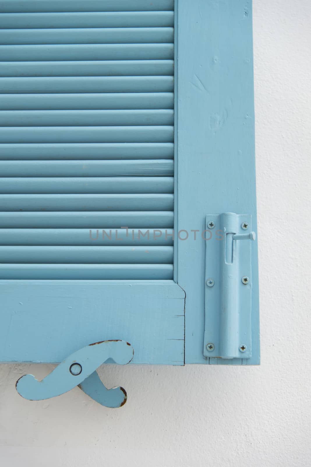 Blue wooden window on white wall3