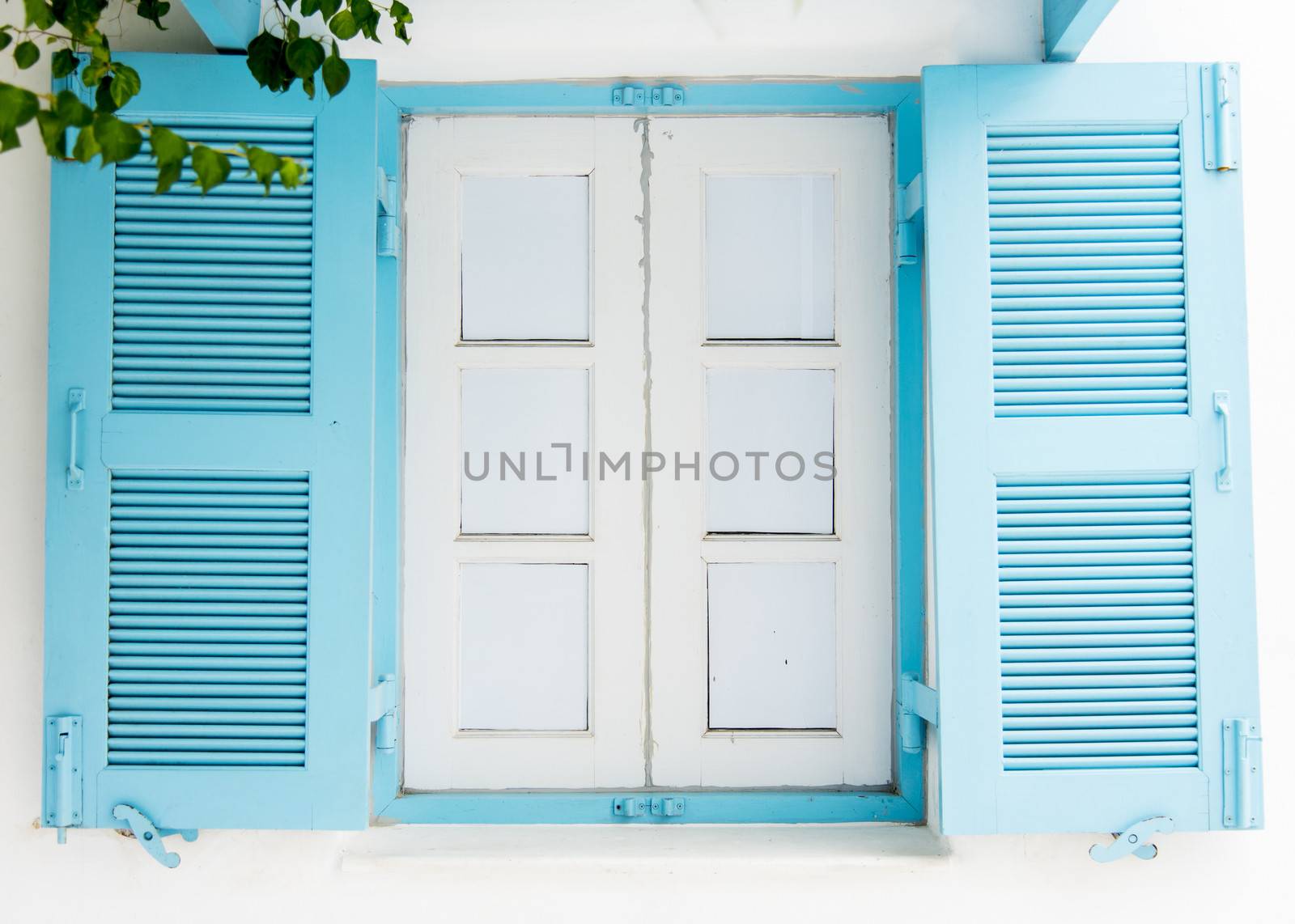 Blue wooden window on white wall1