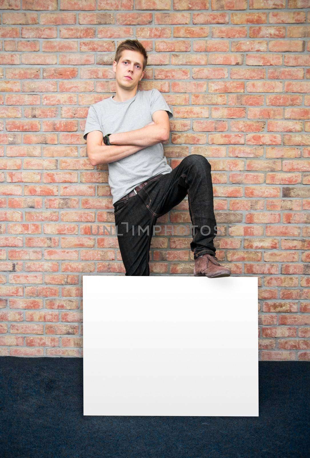 Young man holding blank whiteboard on business presentation