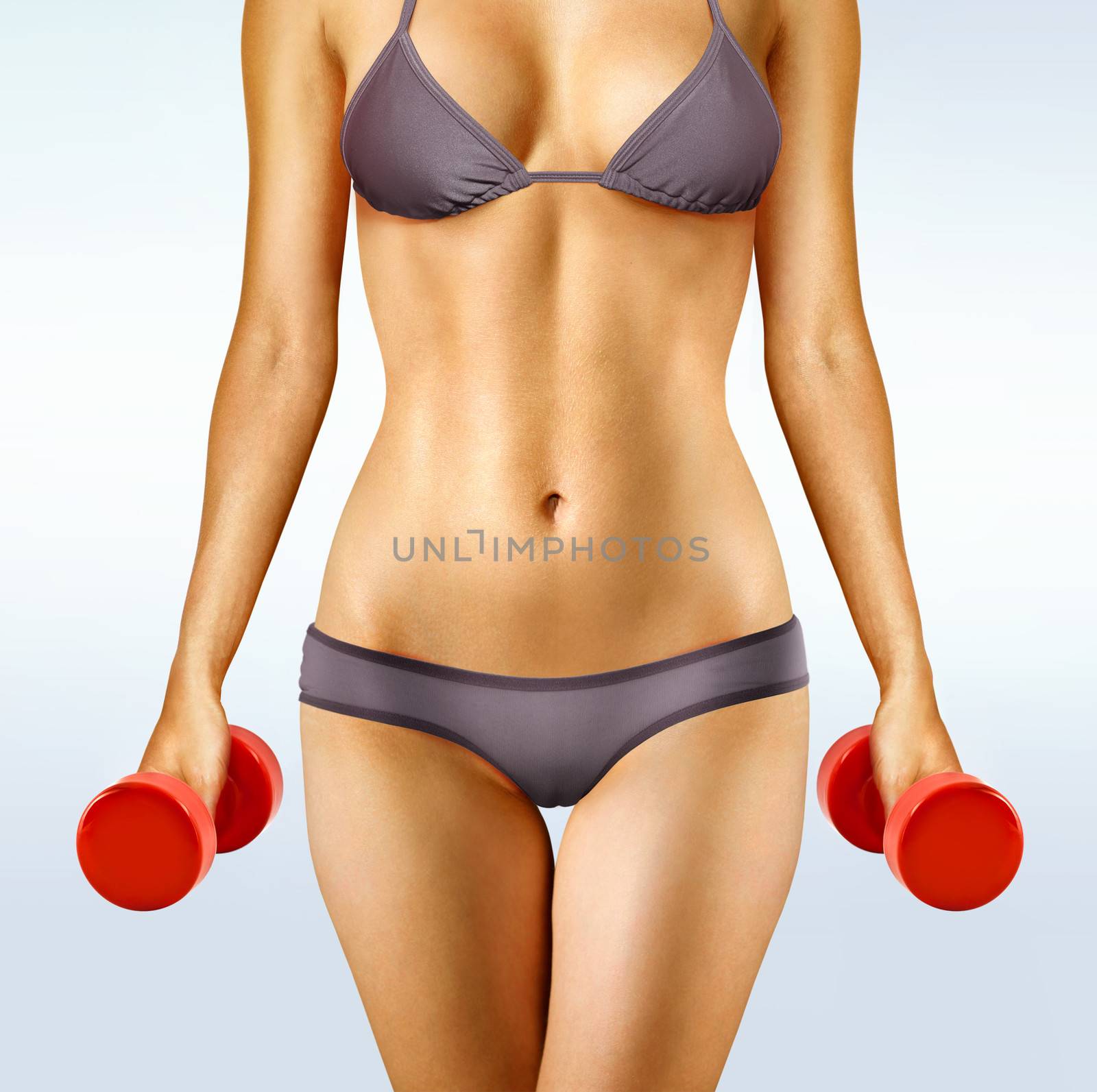 body of woman that working out with red dumbbells