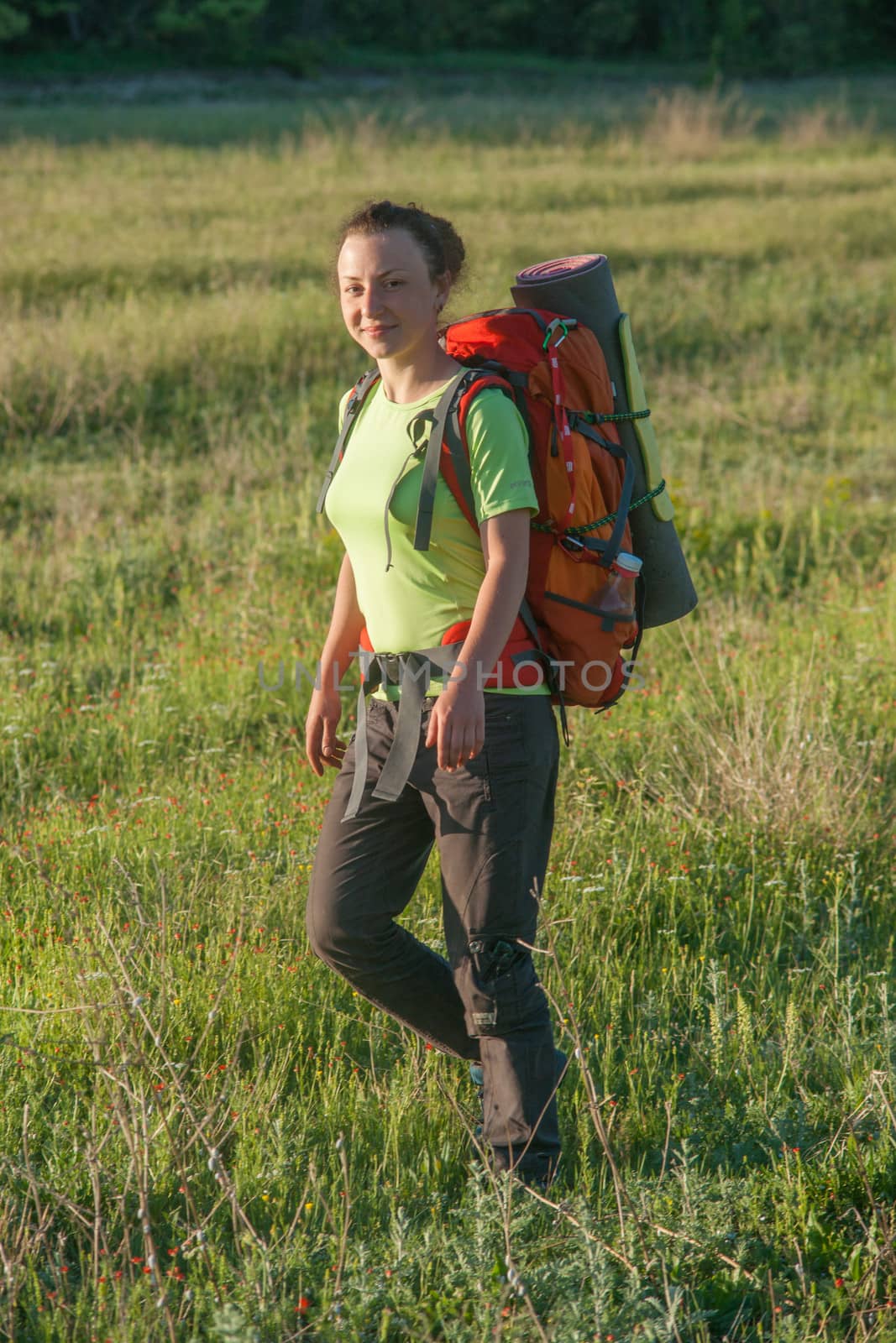 Happy smiling woman in field by kozak
