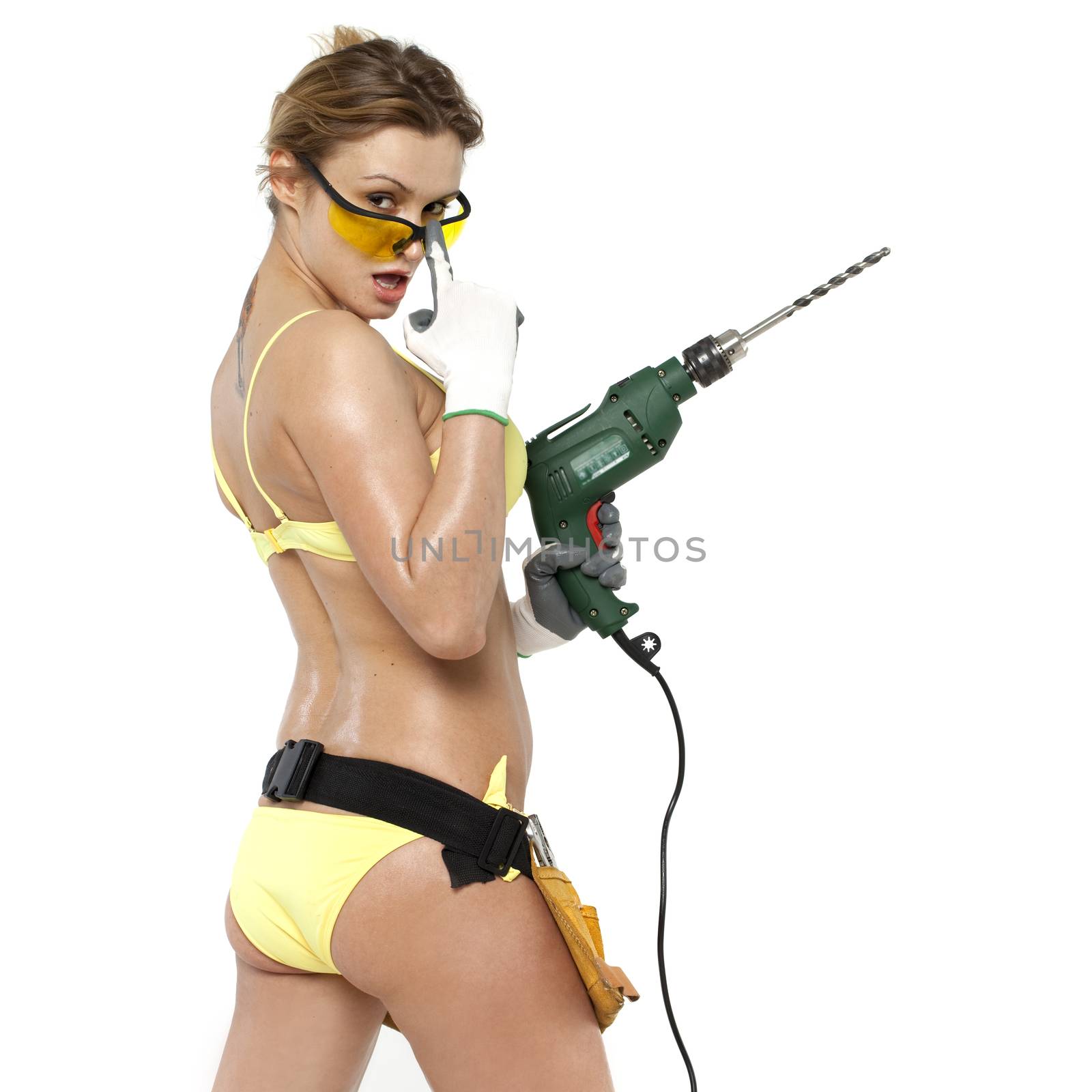 Young sexy woman holding a construction drill