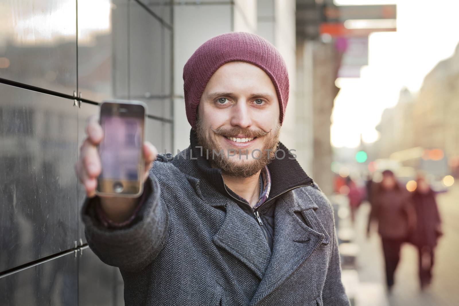 Young man with smartphone by Kor