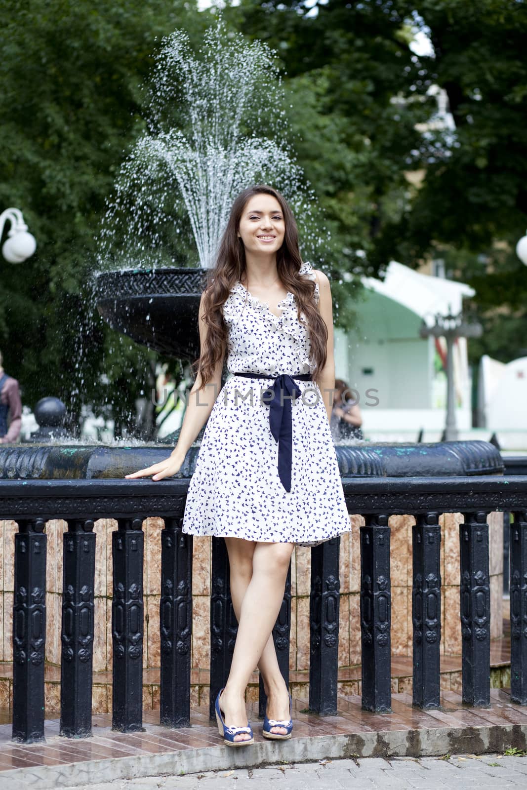 Portrait of young woman in white dress