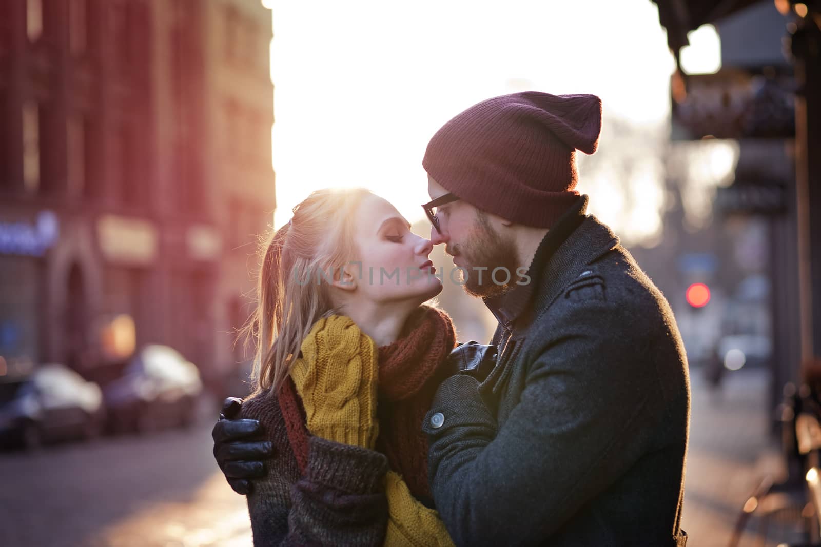 Young happy couple hugging on the city street