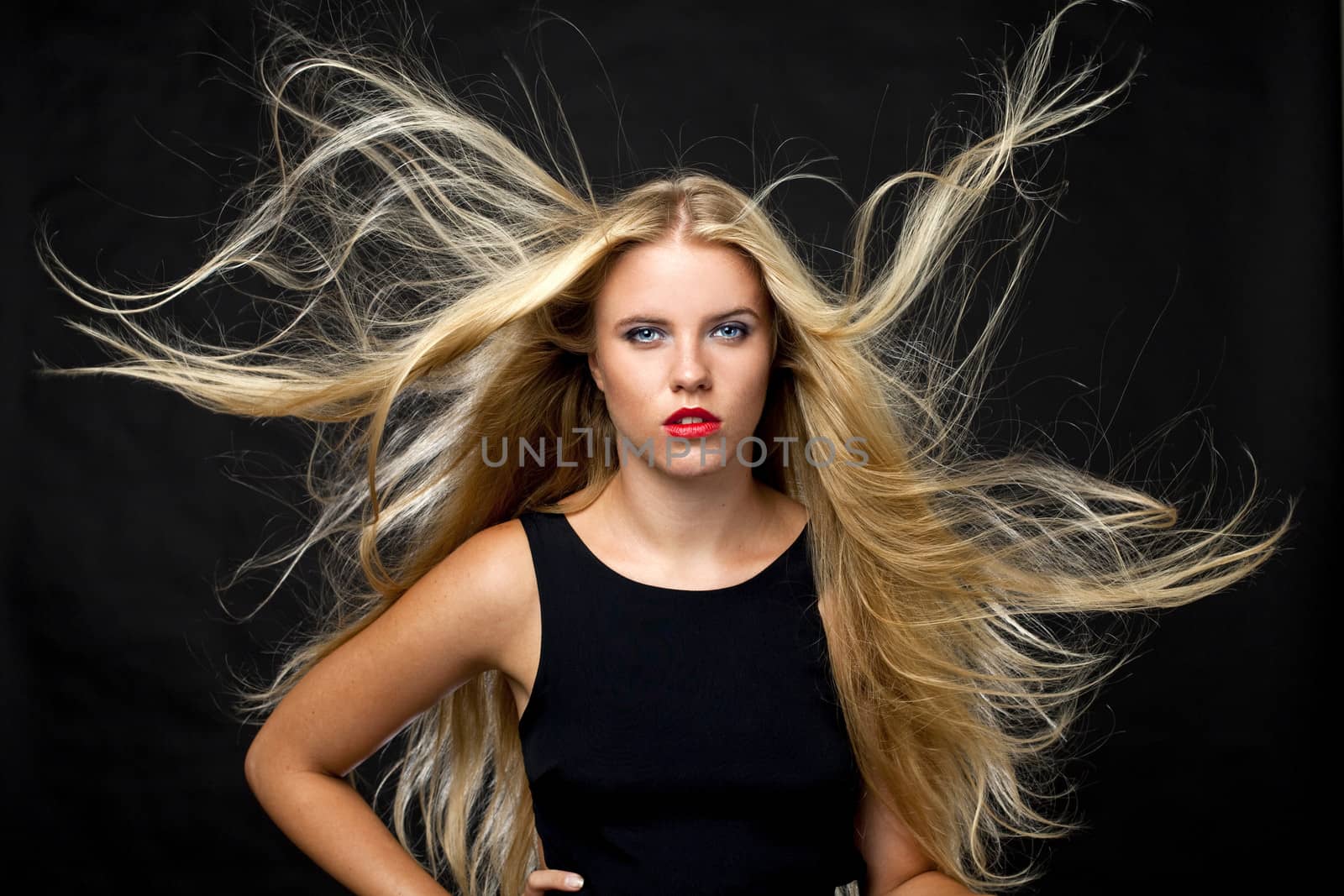 Portrait of beautiful woman in dark studio