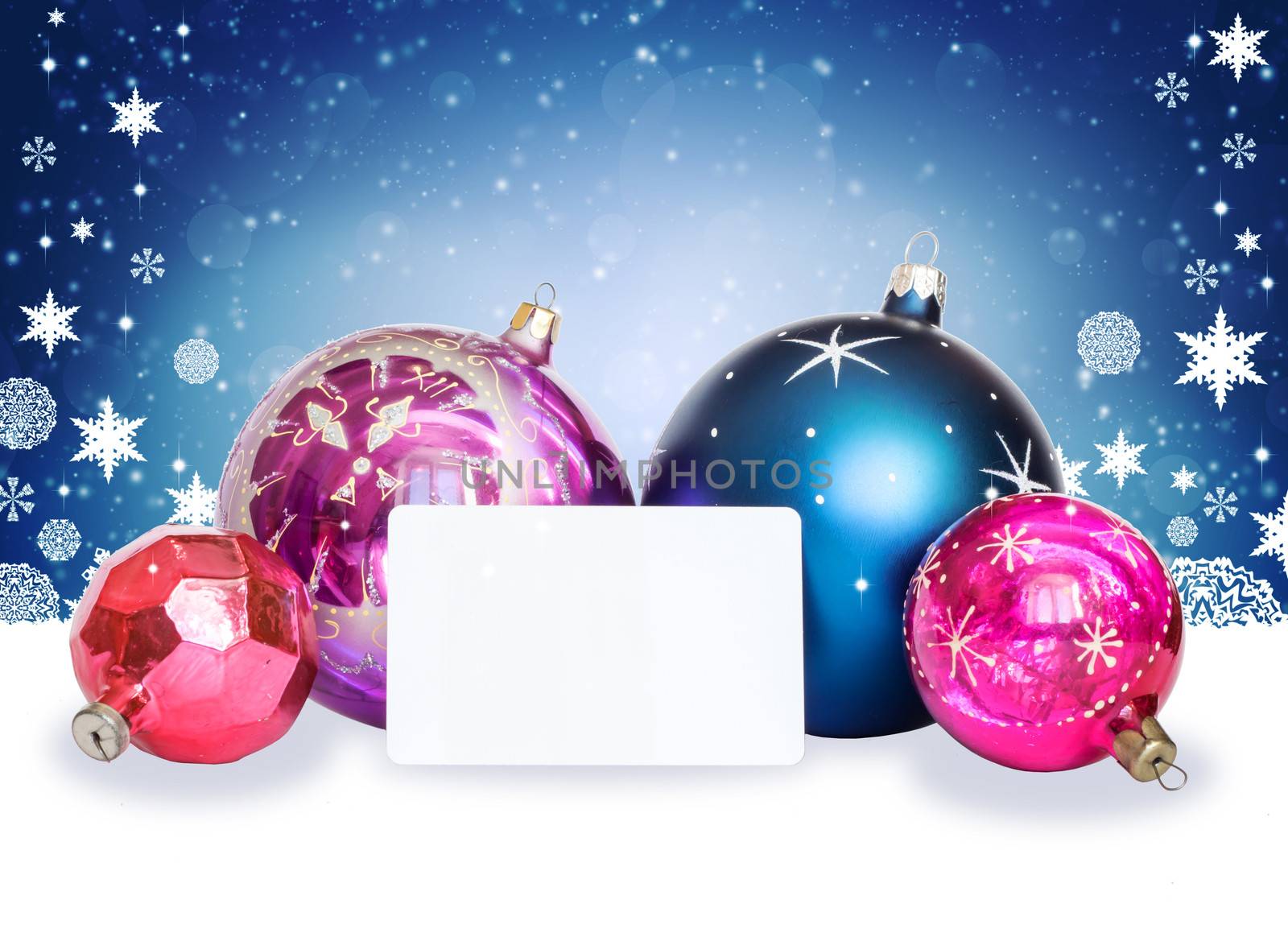 New Year's background. Christmas balls, snowflakes and white card on abstract background