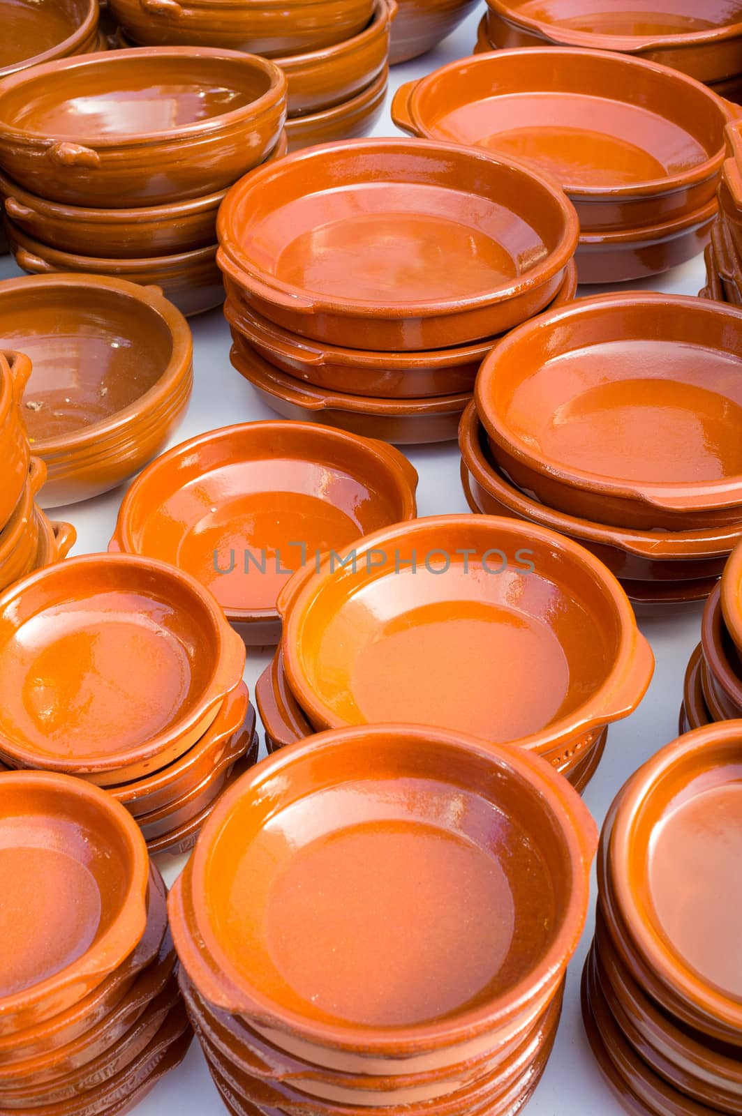 Many  earthnware bowls and pans for sale on a market stall