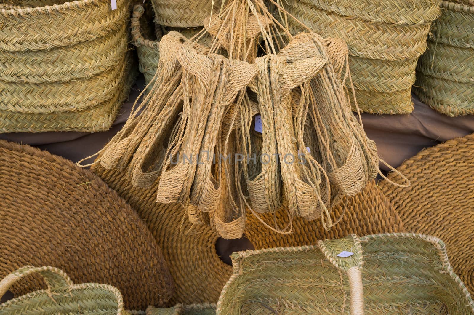 Many different items of wickerwork on a street market stall