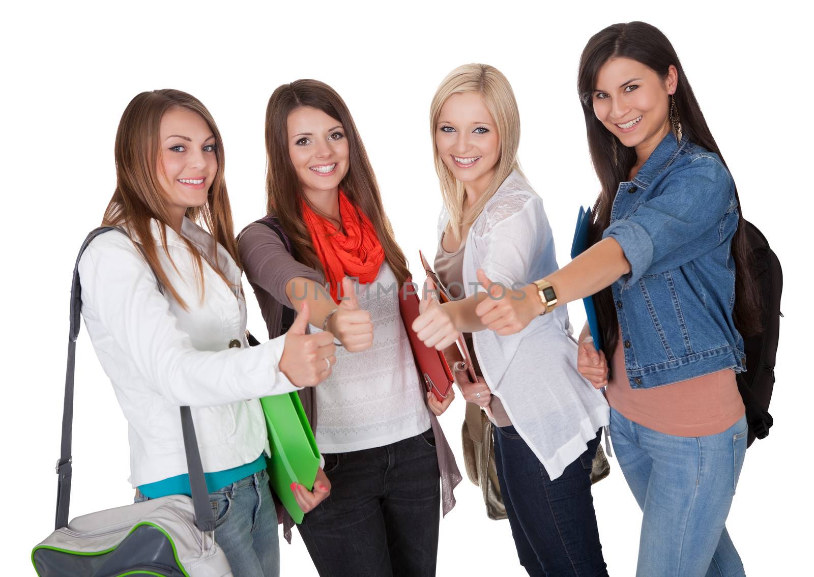 Happy female students are showing a thumbs up isolated on white