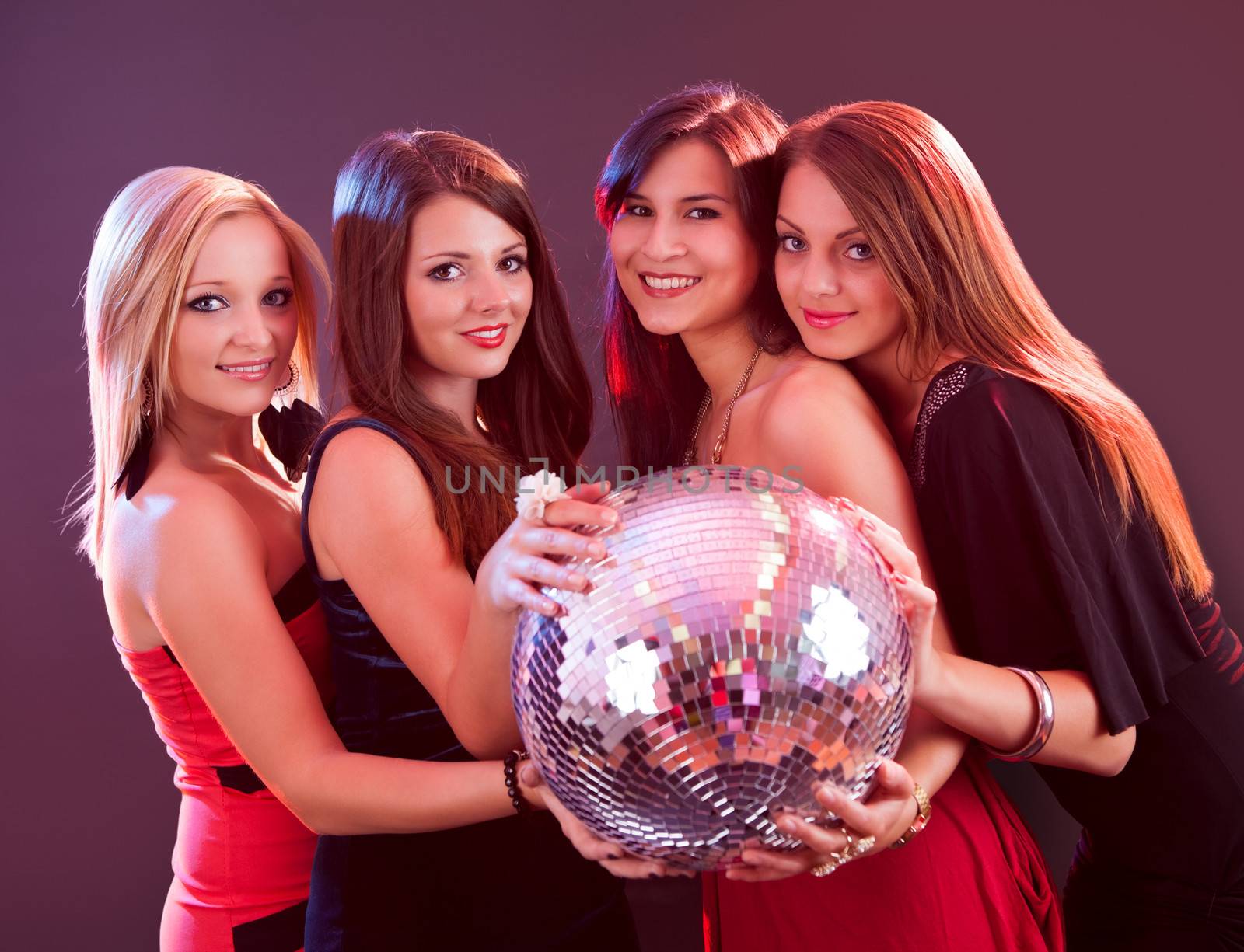 Four attractive females are holding disco ball