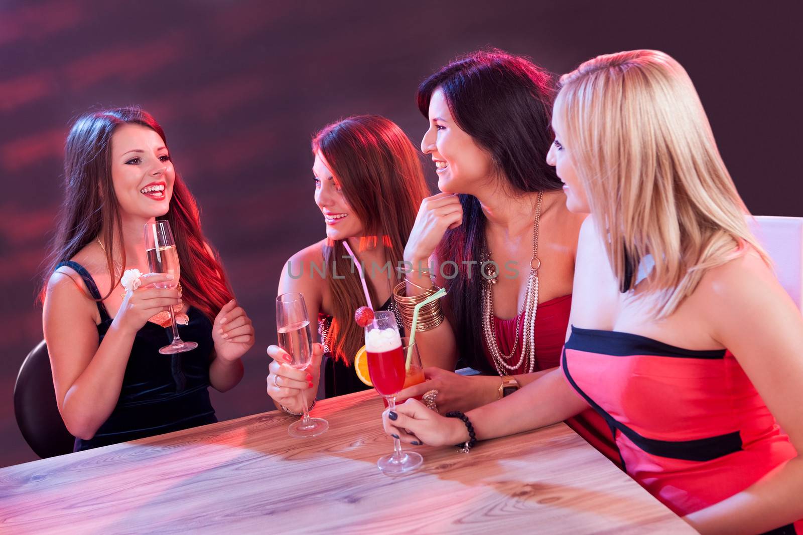 Female friends enjoying a night out by AndreyPopov