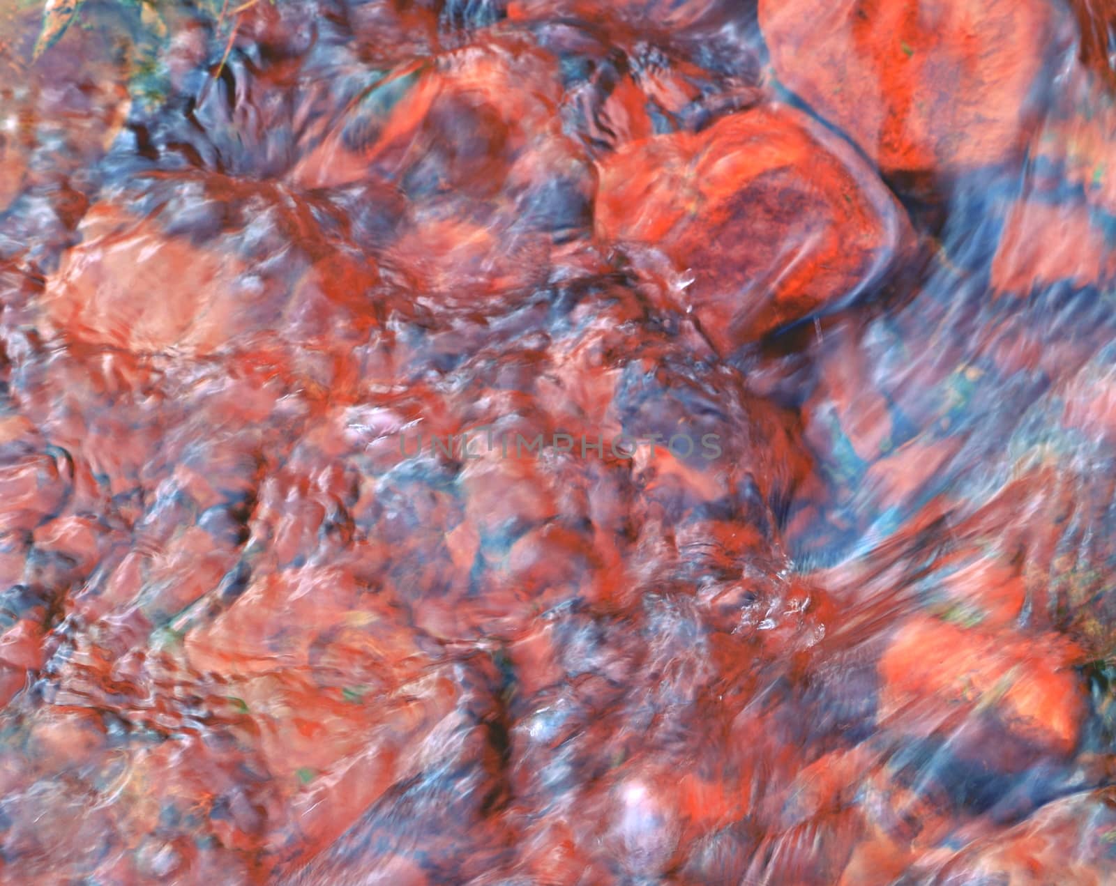 playful ripples pink color ferrous water of a river