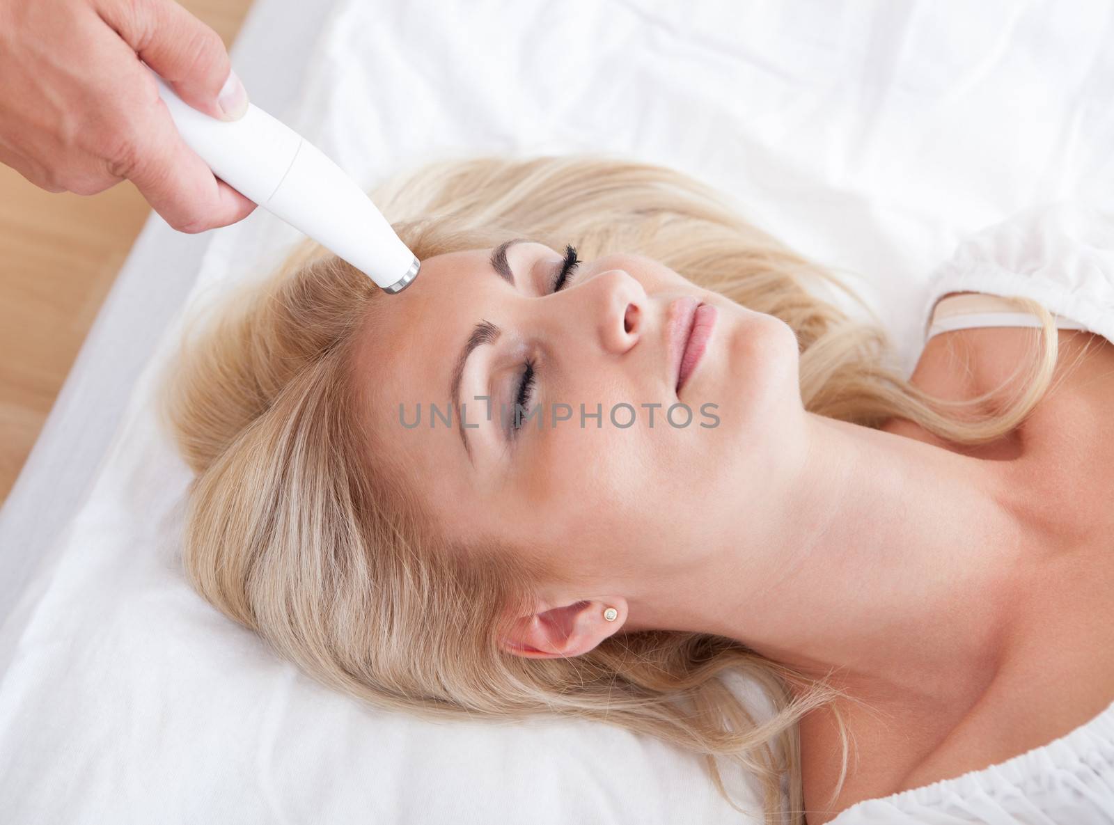 Profile View Of Happy Young Woman During Cosmetic Treatment, Indoors