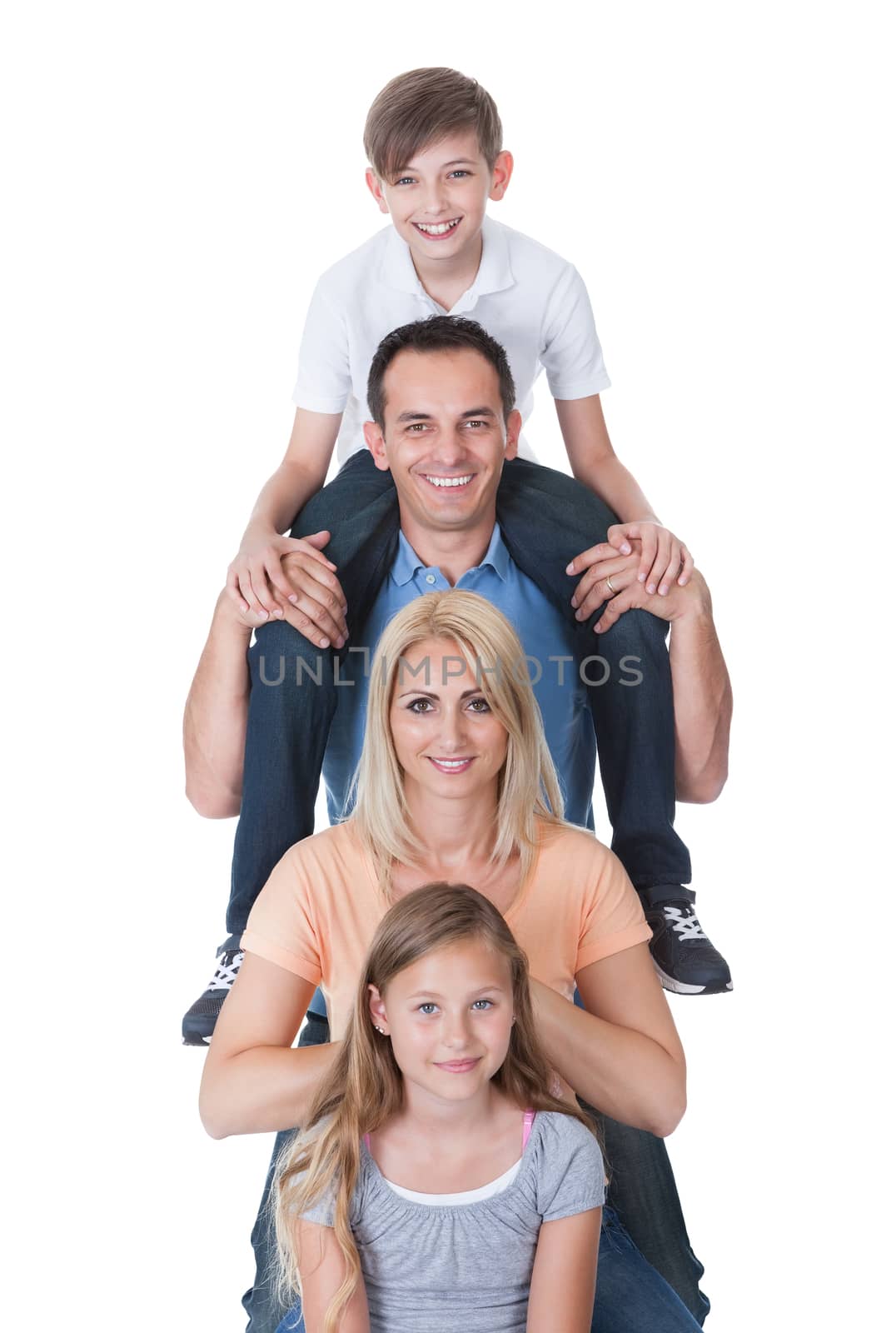 Portrait Of Family With Son On Father's Shoulder Isolated On White Background