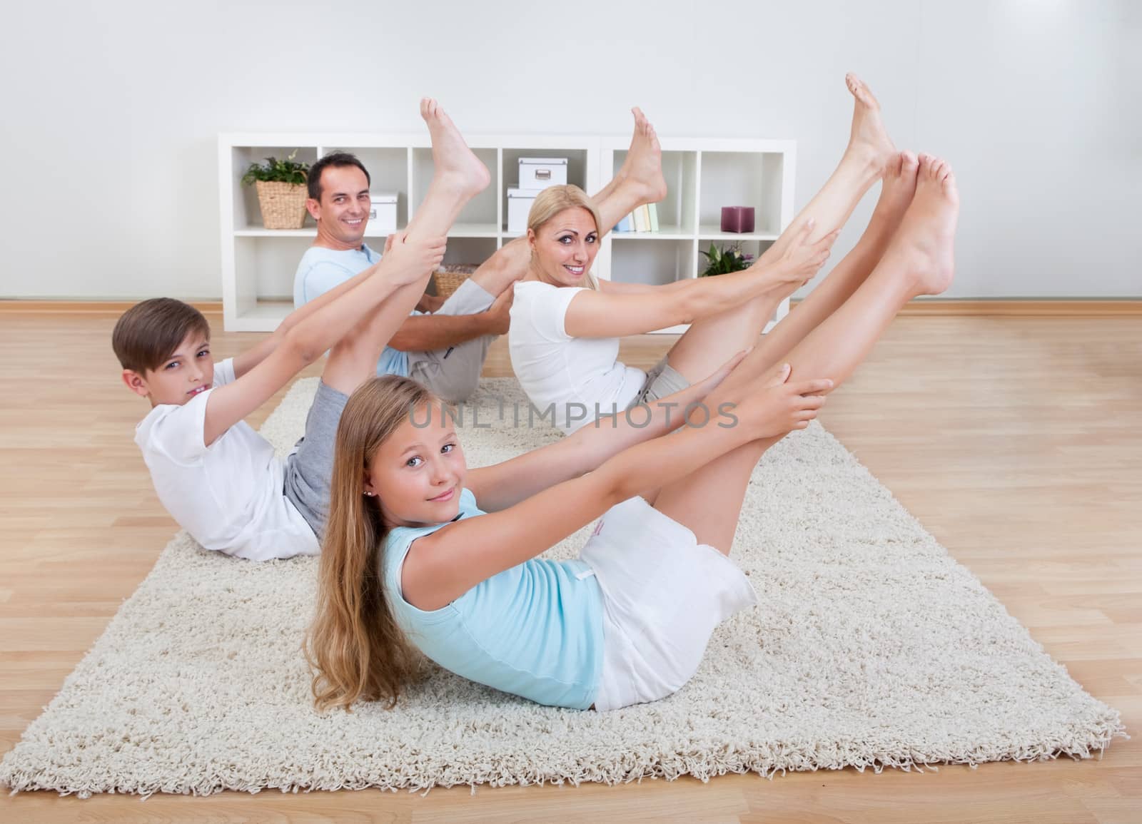 Family Doing Stretching Exercises by AndreyPopov